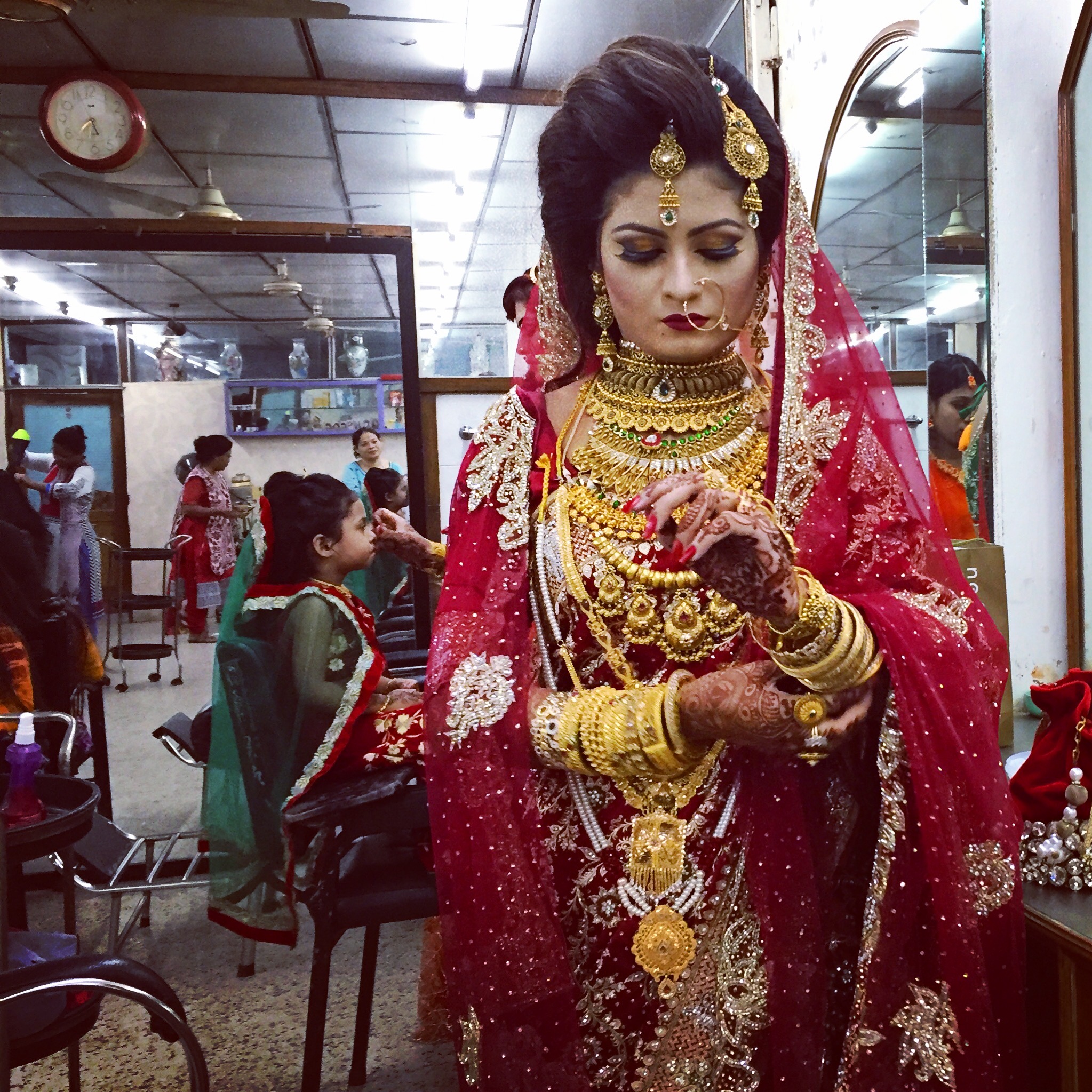  DHAKA | A bride-to-be puts on her gold bangles, the last step in a lengthy process of preparing for her nuptials. July 27, 2016.&nbsp; 