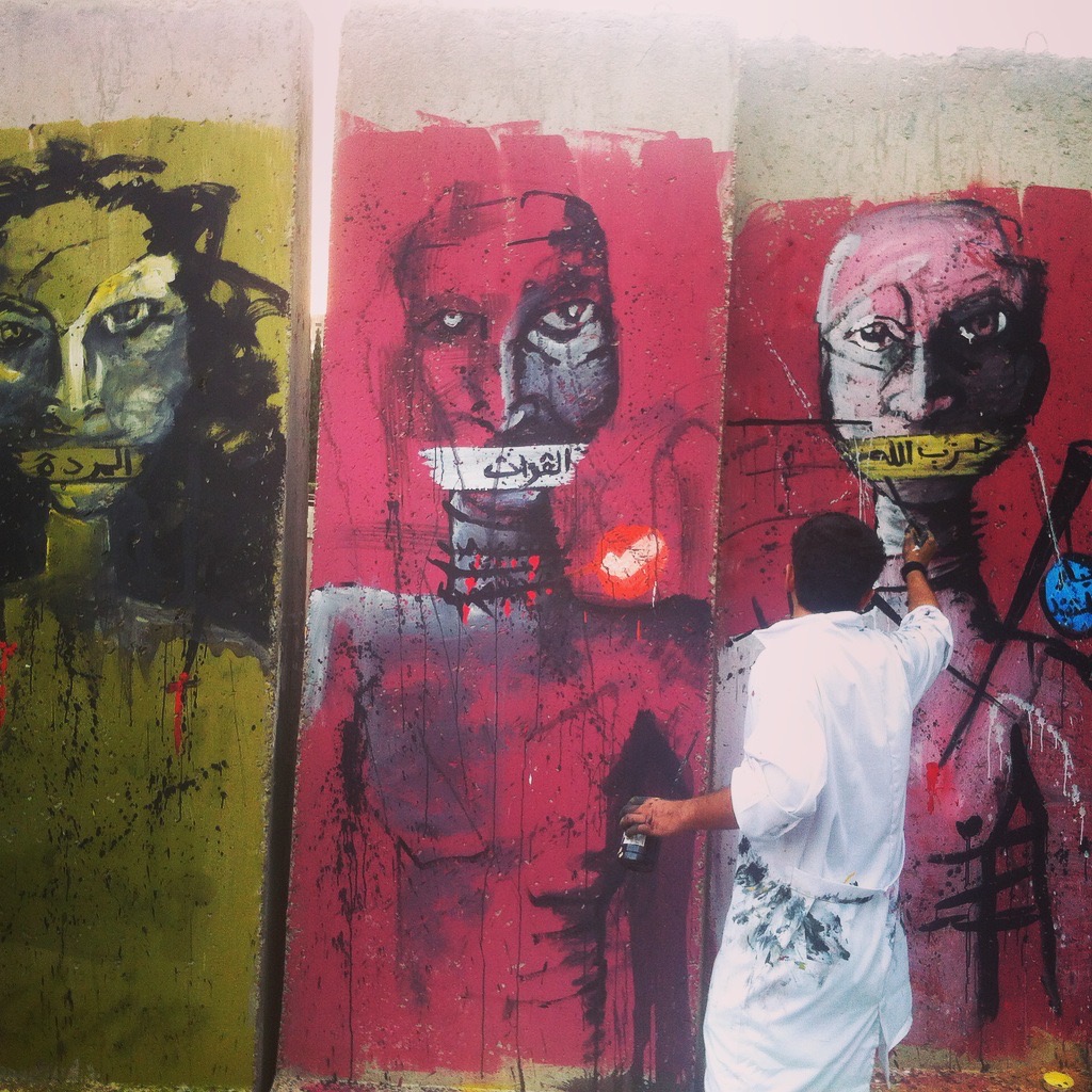 BEIRUT | "You Stink" Protestors paint over cement barriers erected in the Grand Serail by Lebanese security forces. August 25, 2015. 