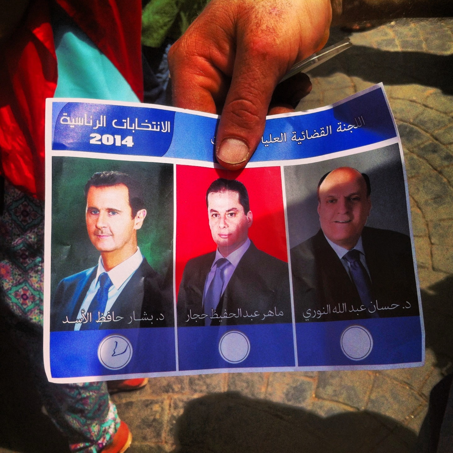  BEIRUT | Ali shows me his ballot form, which he says was distributed before Syrians could enter polling booths. He was among the mob of hundreds crowding the doors leading to the Syrian Embassy in Yarzeh to vote in the election. May 28, 2014.&nbsp; 