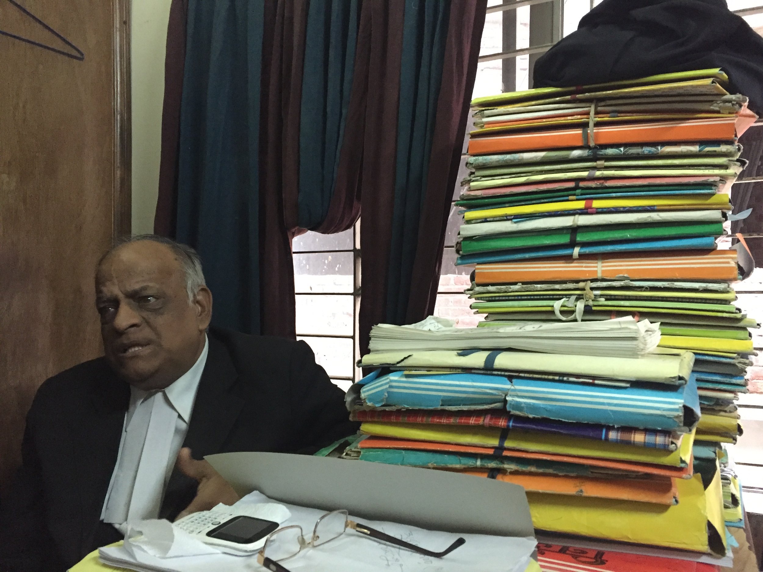  DHAKA | Meeting Rabindra Ghosh, a human rights lawyer defending minority rights. To the right a pile of cases filed by Hindus who have been forcibly evicted from their homes, assaulted and threatened. Bangladesh's minorities - Hindus, Christians, Bu
