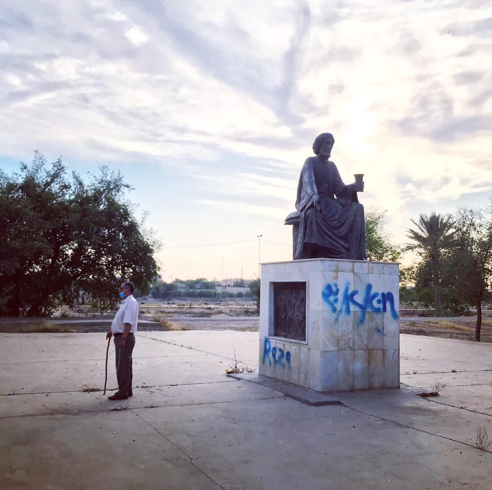  BAGHDAD | Afternoon stroll, stillness. A man quietly reads verses penned by poet Abu Nuwas minutes before curfew. April 30, 2020.  