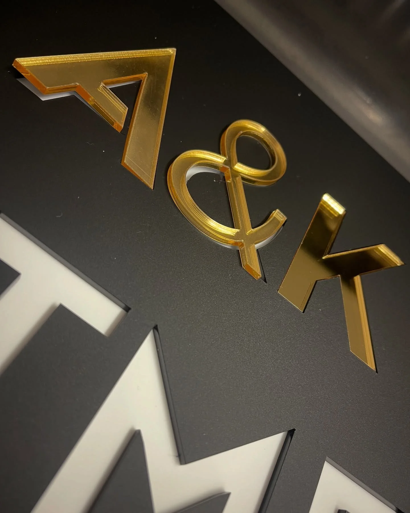 Laser cutting acrylic options for a sign using metallic and natural