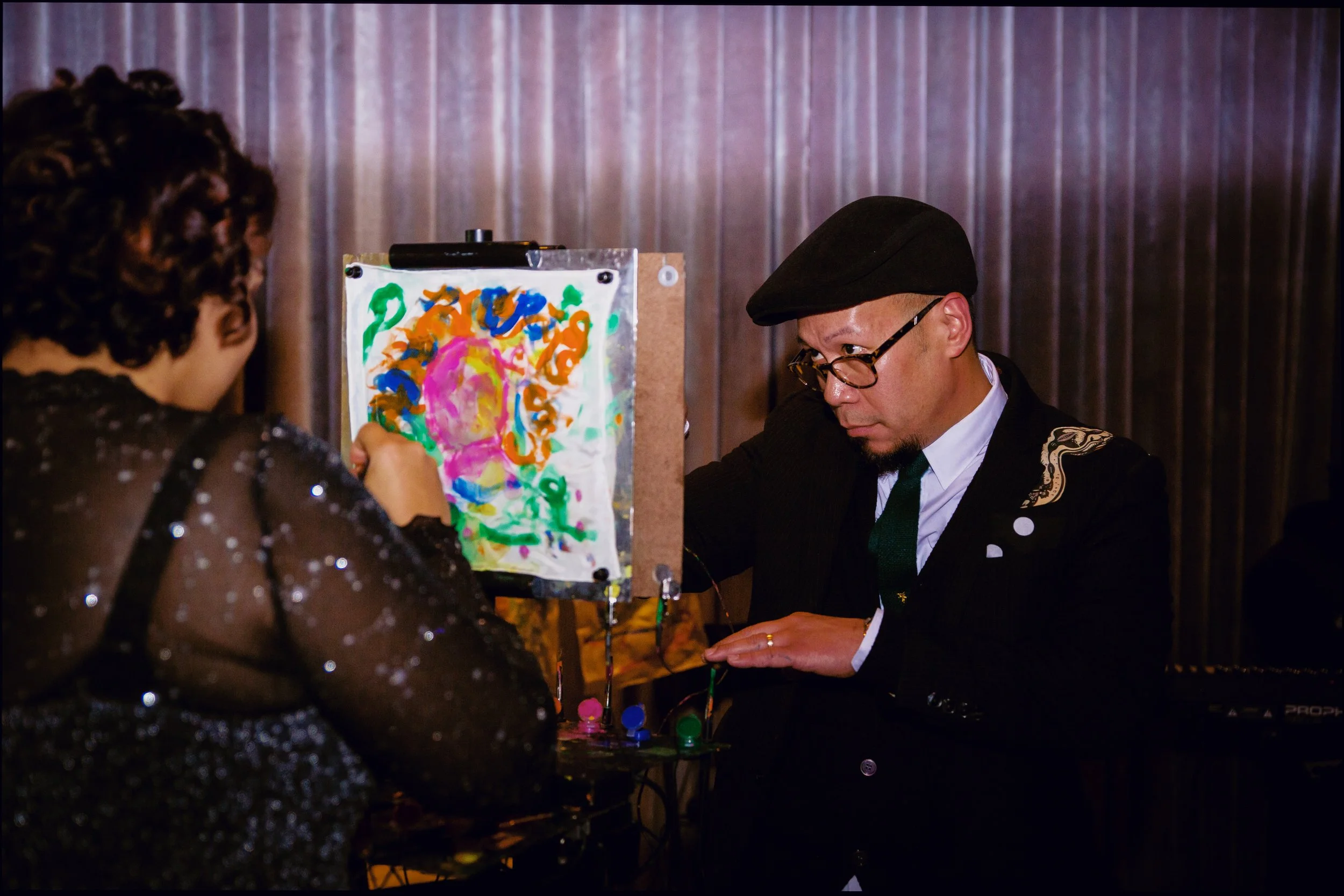 An Artist showing off his painting at an event