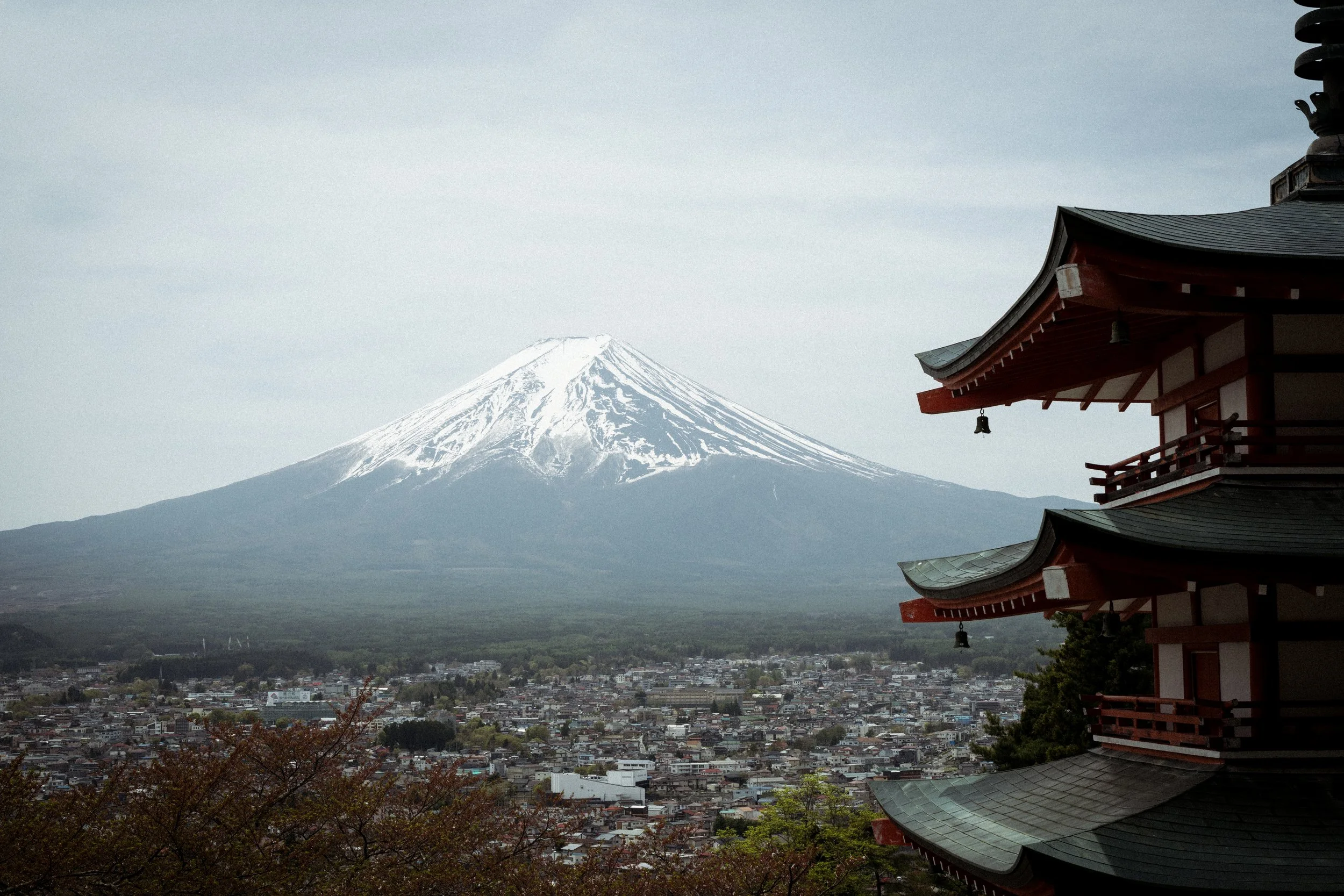 Mount Fuji with red pagoda and city below in autumn