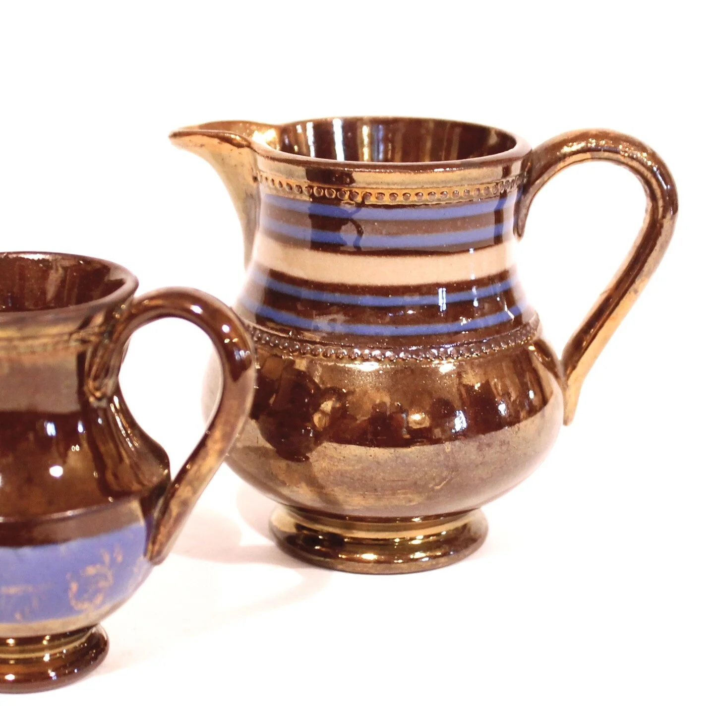 Pair of Small Dark Copper Lustre Ware Cream Pitchers