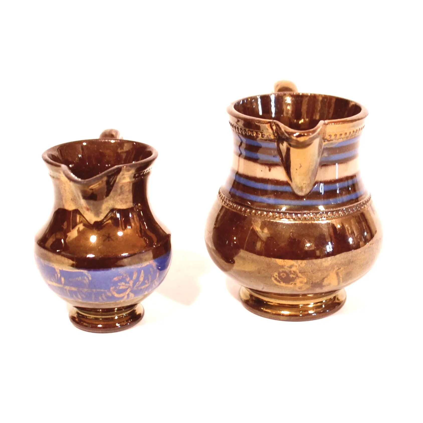 Pair of Small Dark Copper Lustre Ware Cream Pitchers