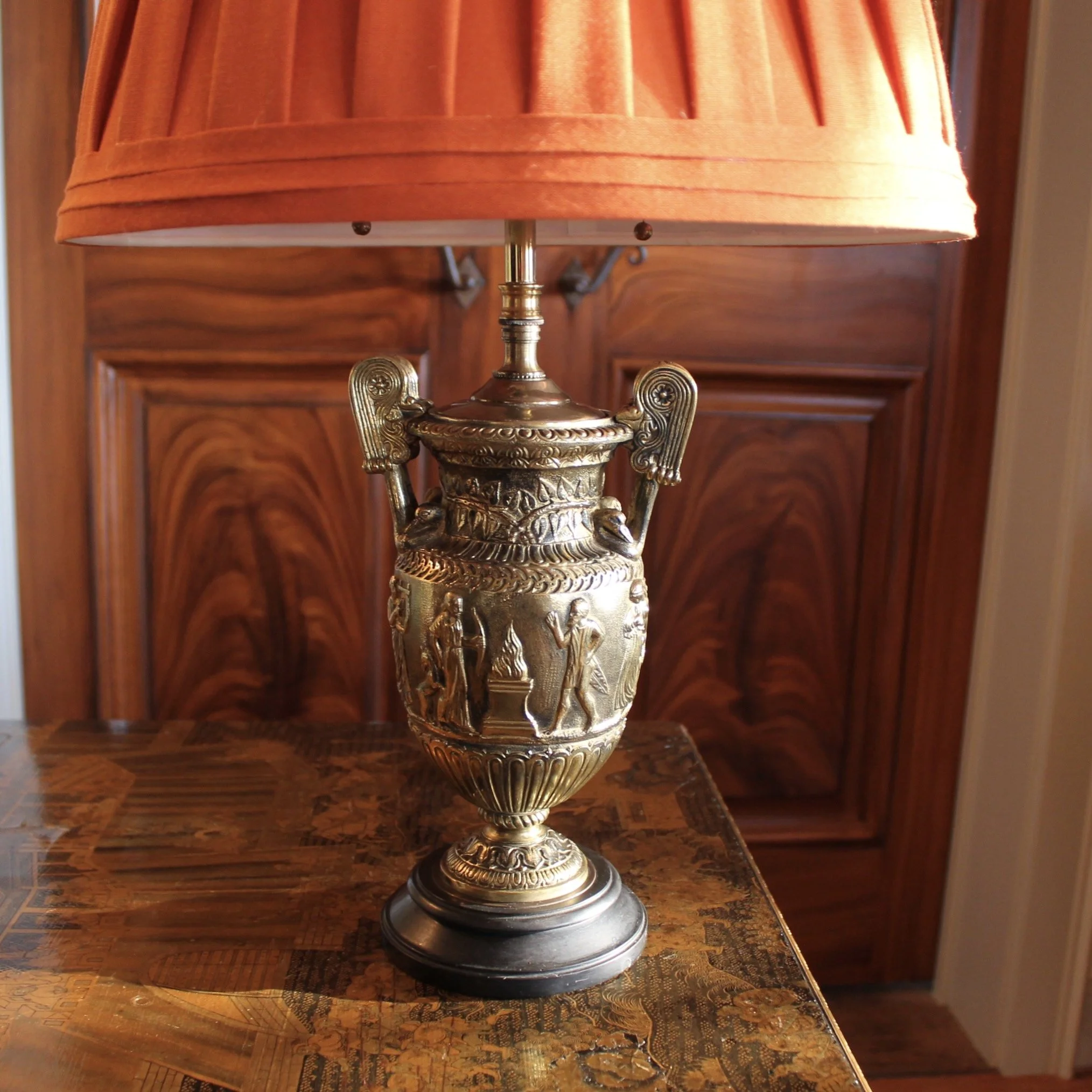 Pair of Polished Bronze Neoclassical Urn Lamps with Orange Linen Shades