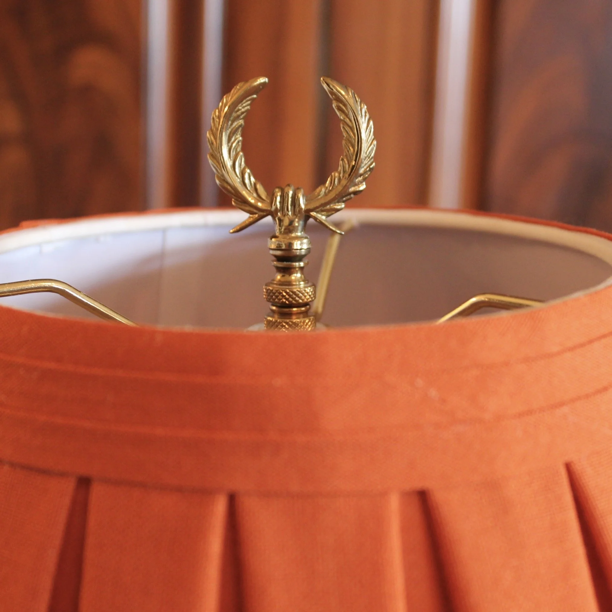 Pair of Polished Bronze Neoclassical Urn Lamps with Orange Linen Shades