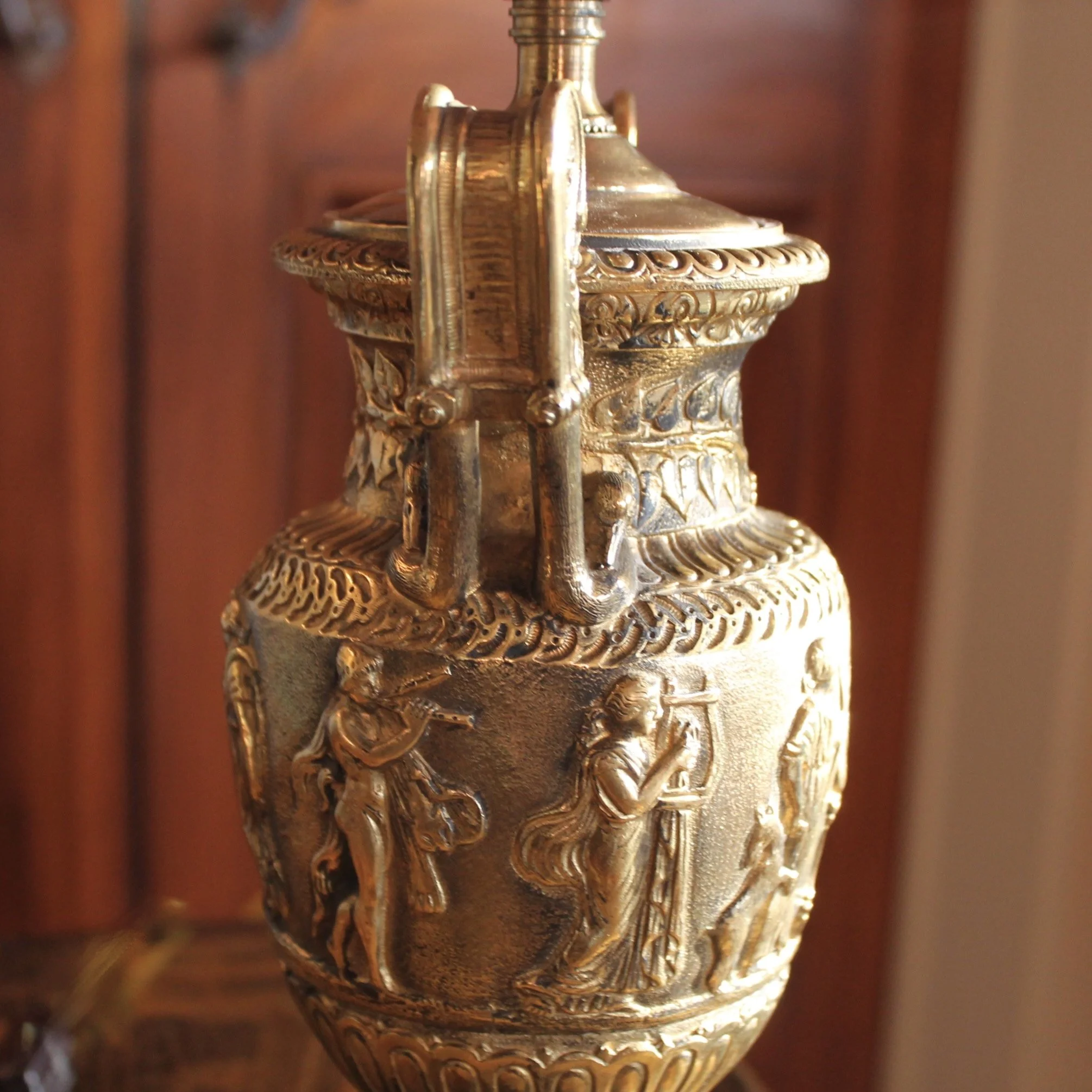 Pair of Polished Bronze Neoclassical Urn Lamps with Orange Linen Shades