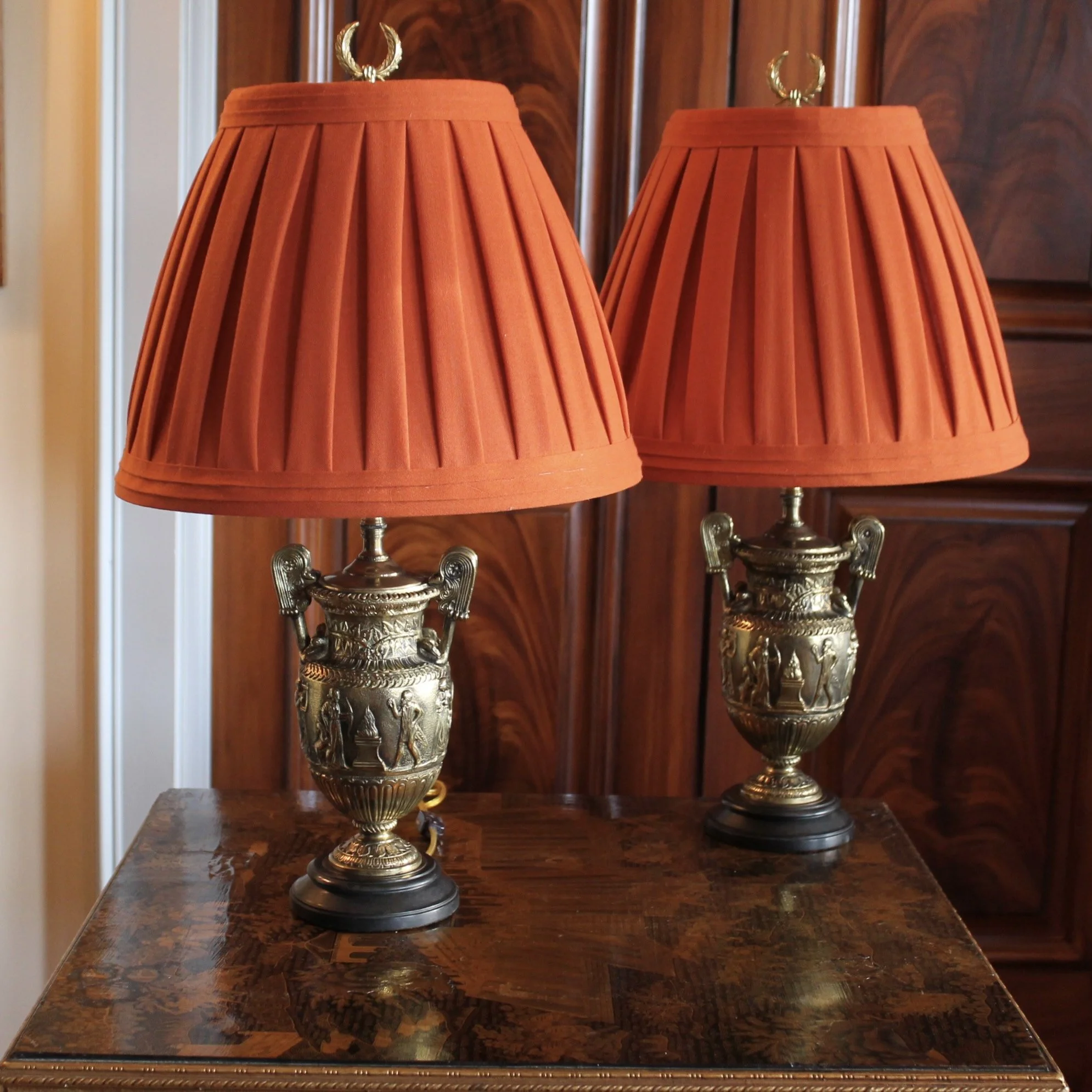 Pair of Polished Bronze Neoclassical Urn Lamps with Orange Linen Shades