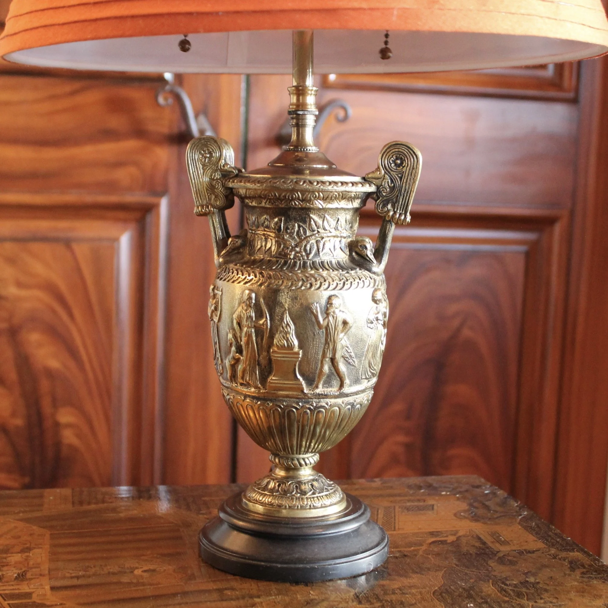 Pair of Polished Bronze Neoclassical Urn Lamps with Orange Linen Shades