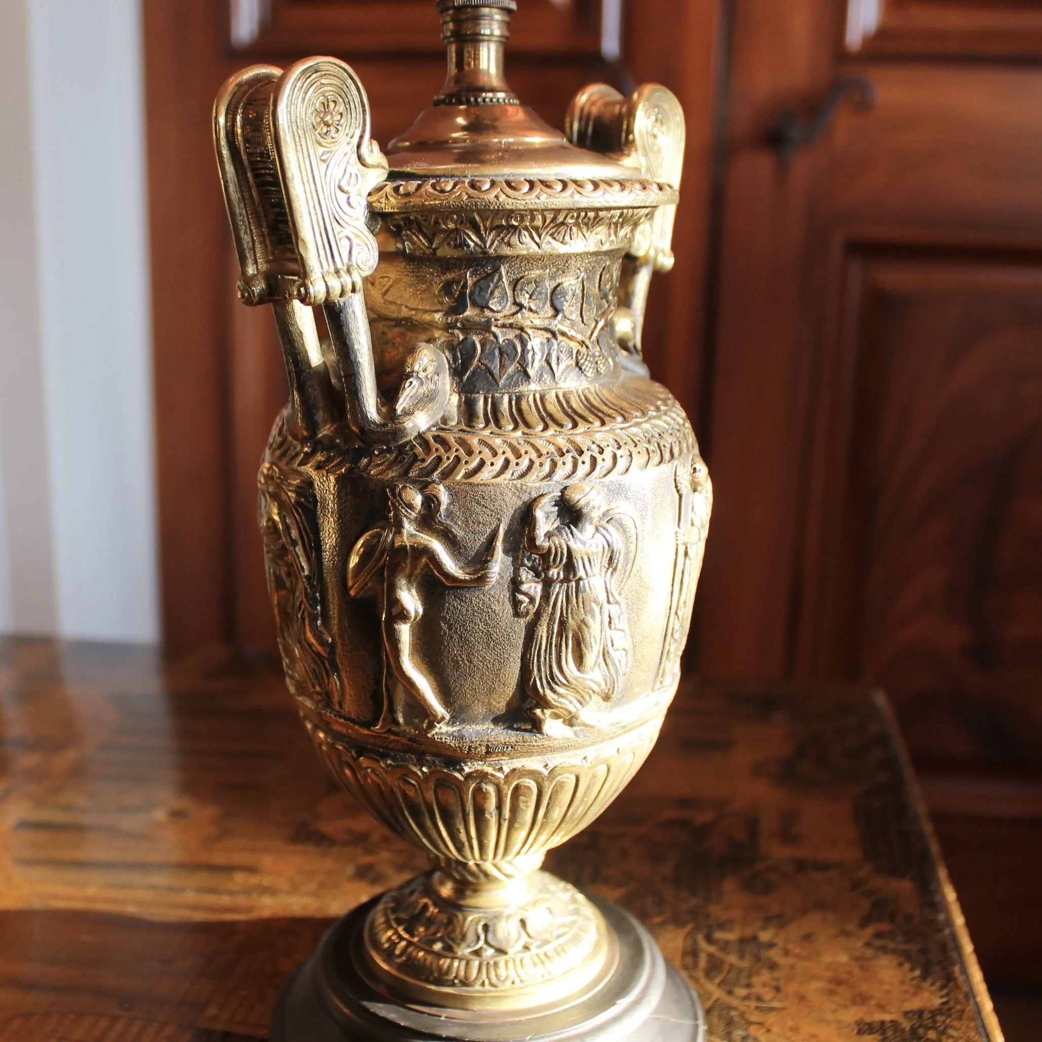 Pair of Polished Bronze Neoclassical Urn Lamps with Orange Linen Shades
