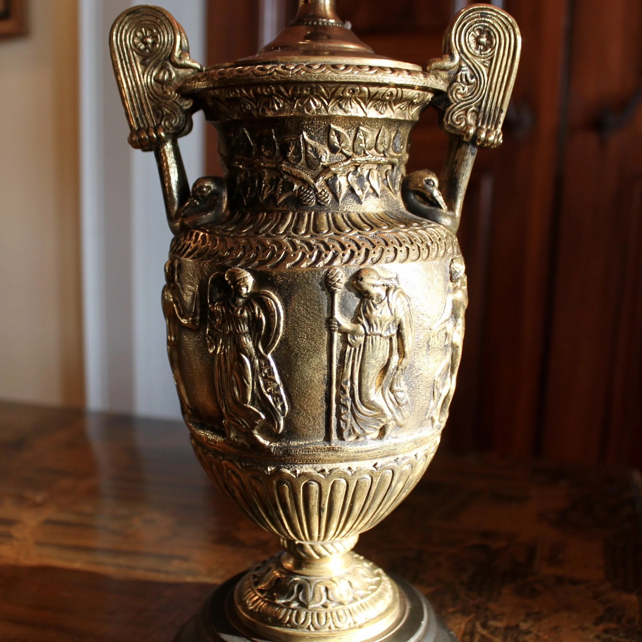 Pair of Polished Bronze Neoclassical Urn Lamps with Orange Linen Shades
