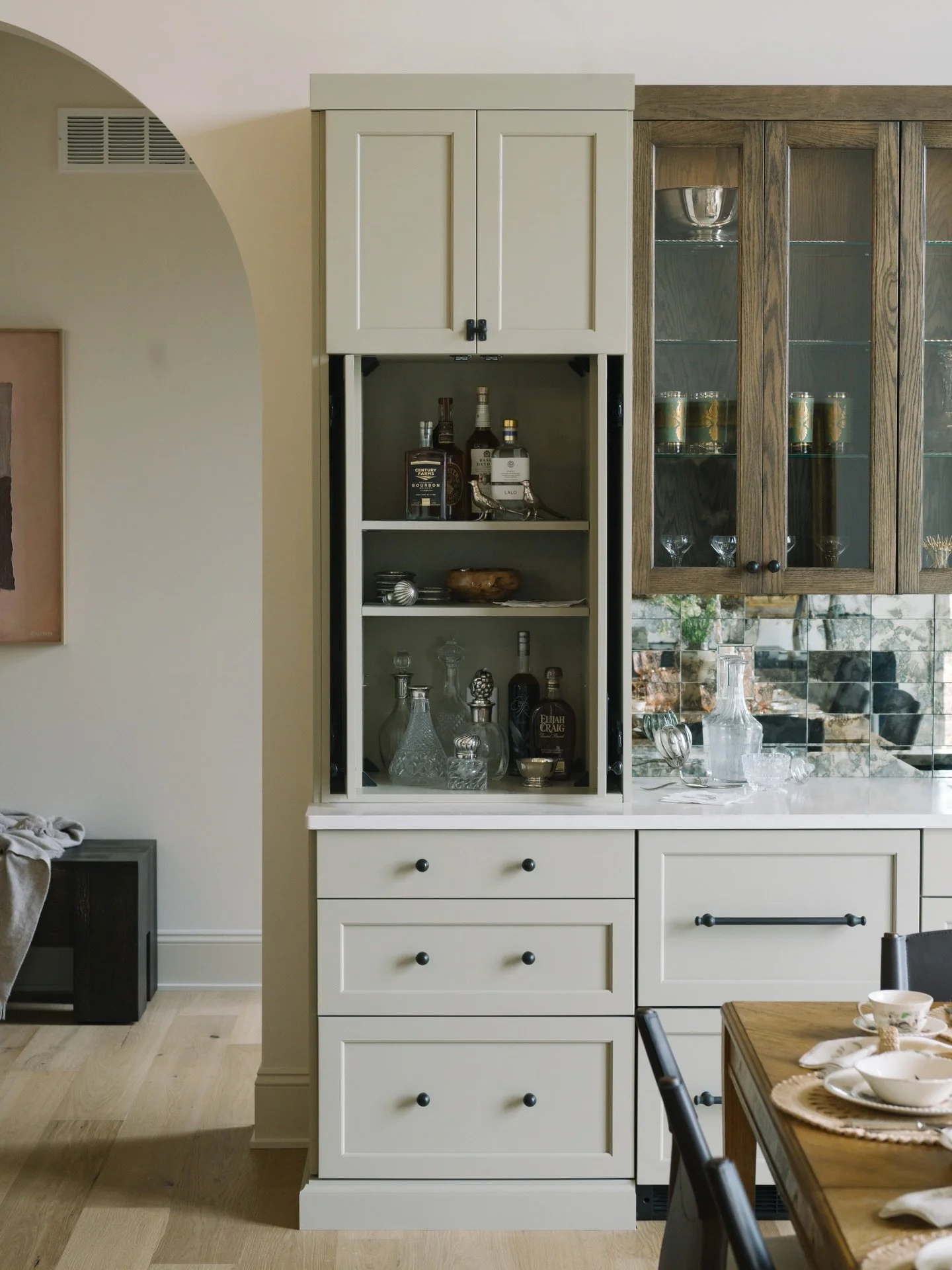 Proof that adulthood is just hiding your bar behind a very responsible-looking cabinet. 

Cabinetry by: CBID/ @holidaykitchens
Flooring by: @shoproyalflooring 
Hardware: @rejuvenation 
📸 @justinsalemmeyer