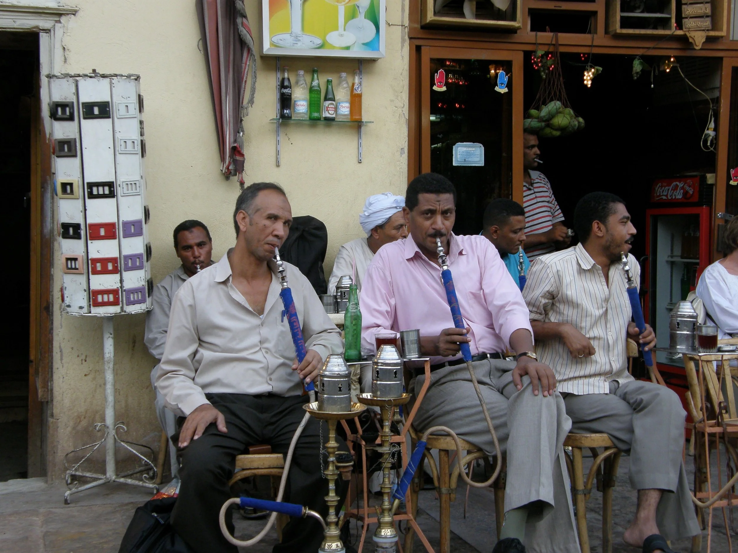 image: Aswan, Egypt 2006. My mom carried an Israeli passport. We flew to Cairo from Tel Aviv and took an Oberoi boat from Luxor to Aswan. State security boarded the boat in Aswan and accompanied us to the market. The men at the cafe followed us with a gaze mixed with desire and hostility. It was never clear if the security was there to protect us or keep an eye on us.