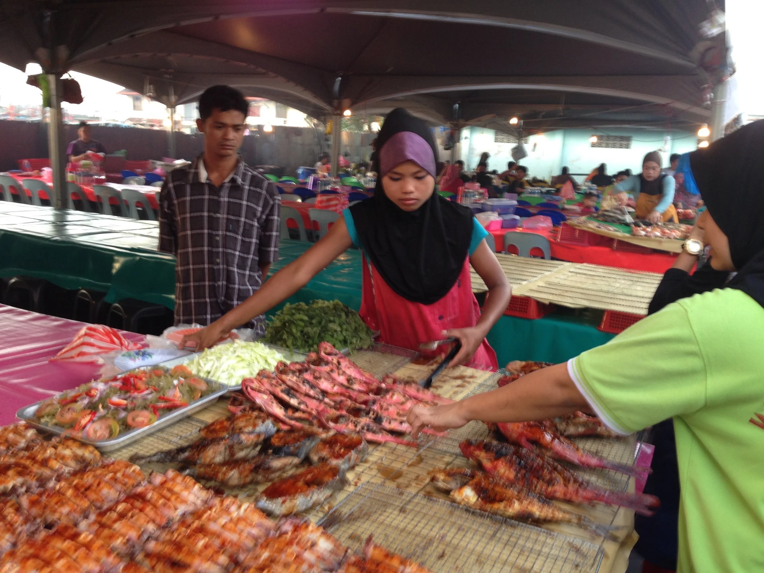 image: Borneo, 2013. At the market, eating seafood I have never seen before, and no one could explain to me what it was.