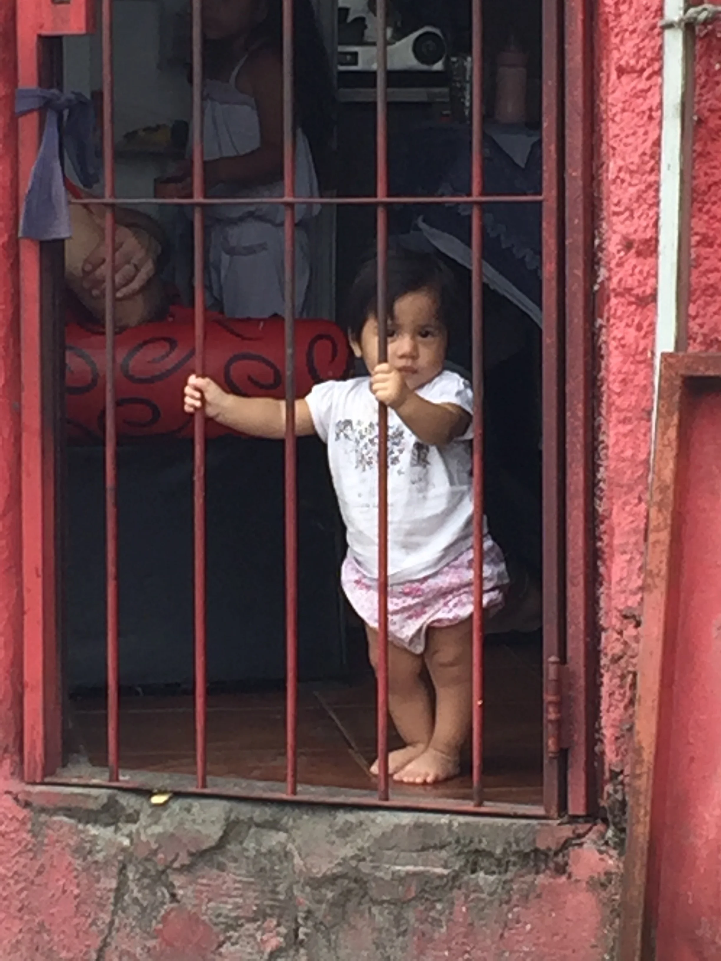 A girl in the Barracas neighborhood, her house in the middle of the largest mural in world. Buenos Aires, 2016