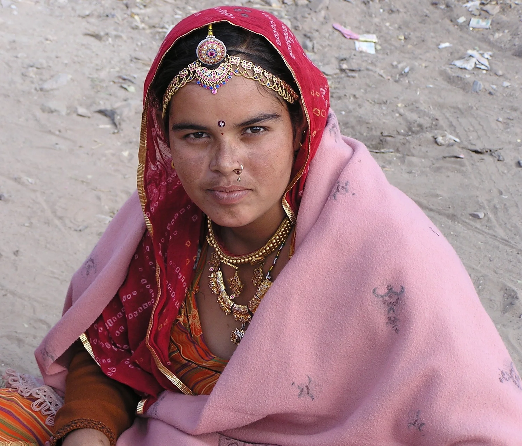 On the side of the road waiting for a bus, somewhere in Jaipur. Her beauty, the colors of her dress and jewelry held my breath. I wish we could have spoken. So many times I longed to sit by the side of the road and ask "tell me about your life, tell me about you".