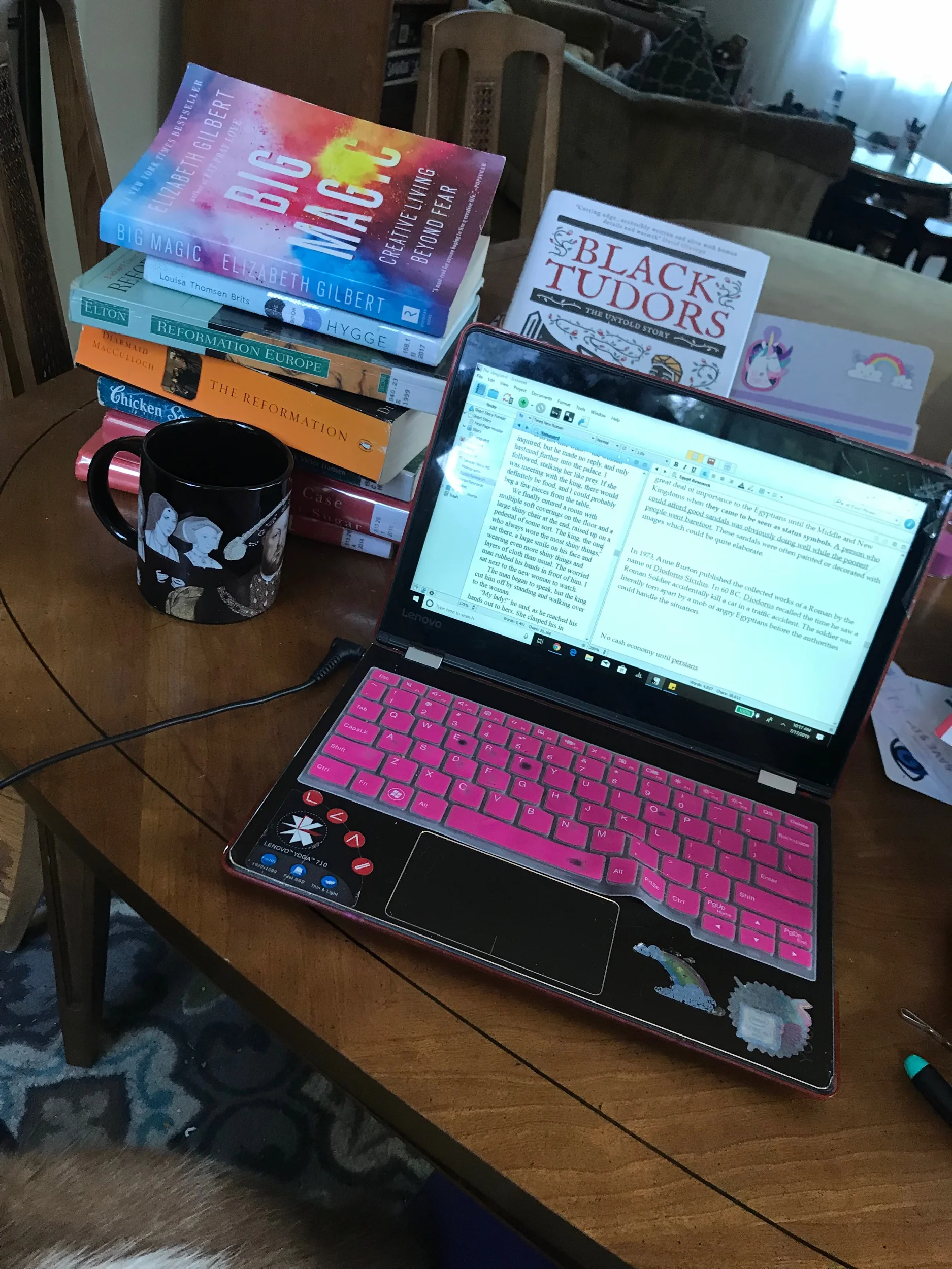 I usually write at the kitchen table these days, surrounded by books and journals.