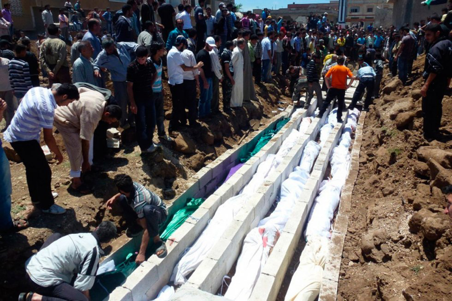 26 May 2012: People gather at a mass burial for the victims killed during an artillery barrage from Syrian forces. UN observers in Syria confirmed that artillery and tank shells were fired at a residential area, where at least 108 people, including many children, were killed. (Source: Reuters)