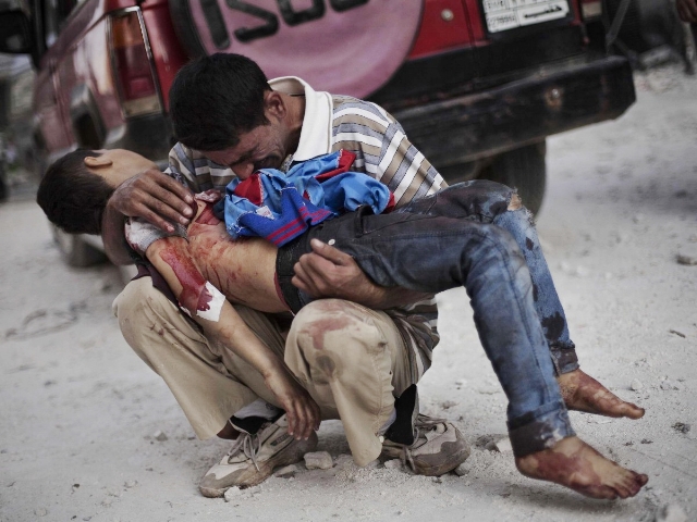  Adult man holding a young boy's corpse on his arms, during the war in Syria. &nbsp;Children are extremely vulnerable to airstrikes, bombing and shelling.&nbsp; 