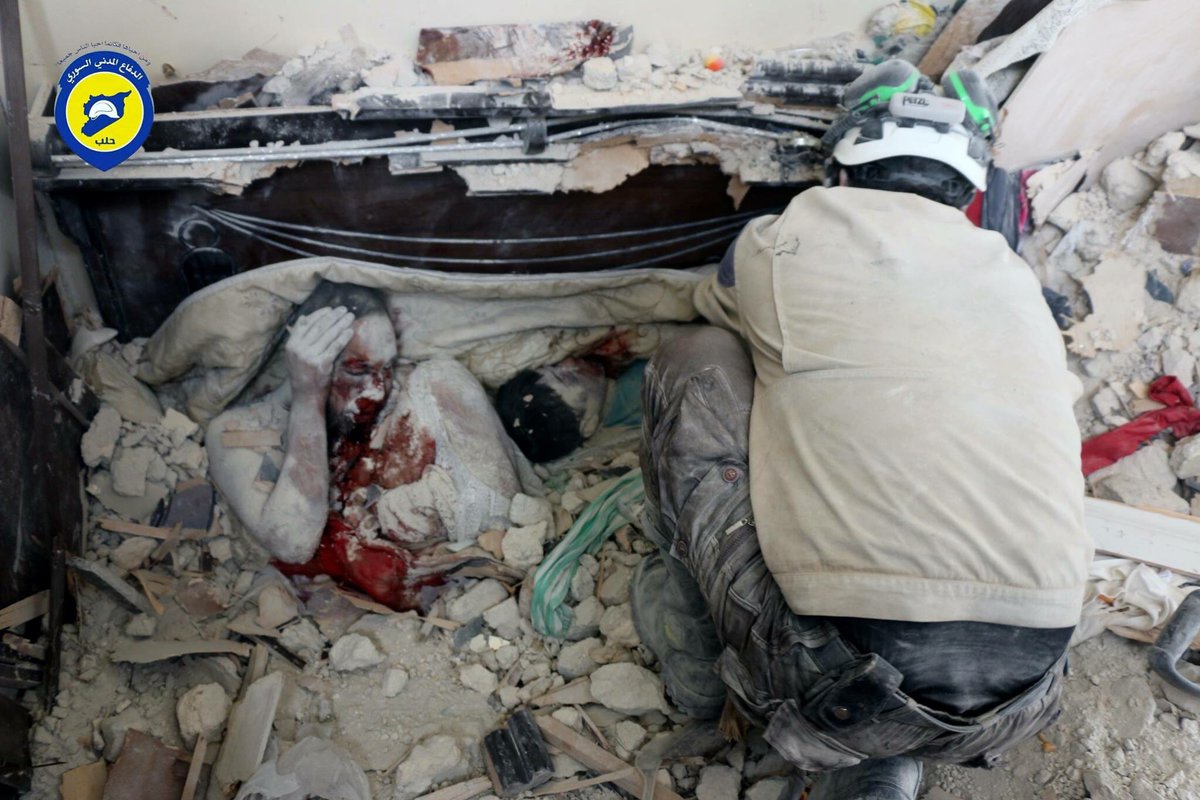 A man and and a child are buried as a result of bombings in civilian areas in Syria.