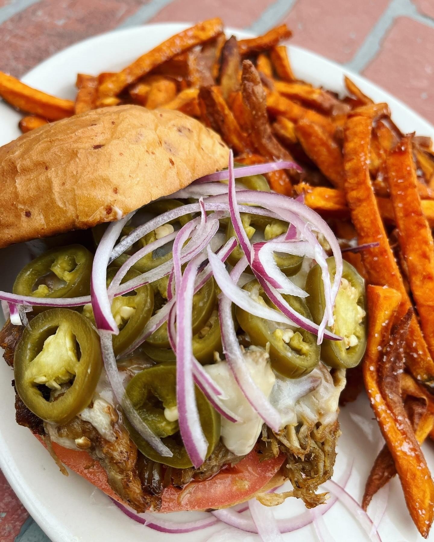 BACK ON SPECIAL! Our Cowboy Candy Pork Sandwich&ndash;Caramelized grilled Cuban pulled pork, on a parmesan bun with tomato, pickled jalape&ntilde;o, red onion, mayo and melted pepper jack cheese, served with your choice of side.