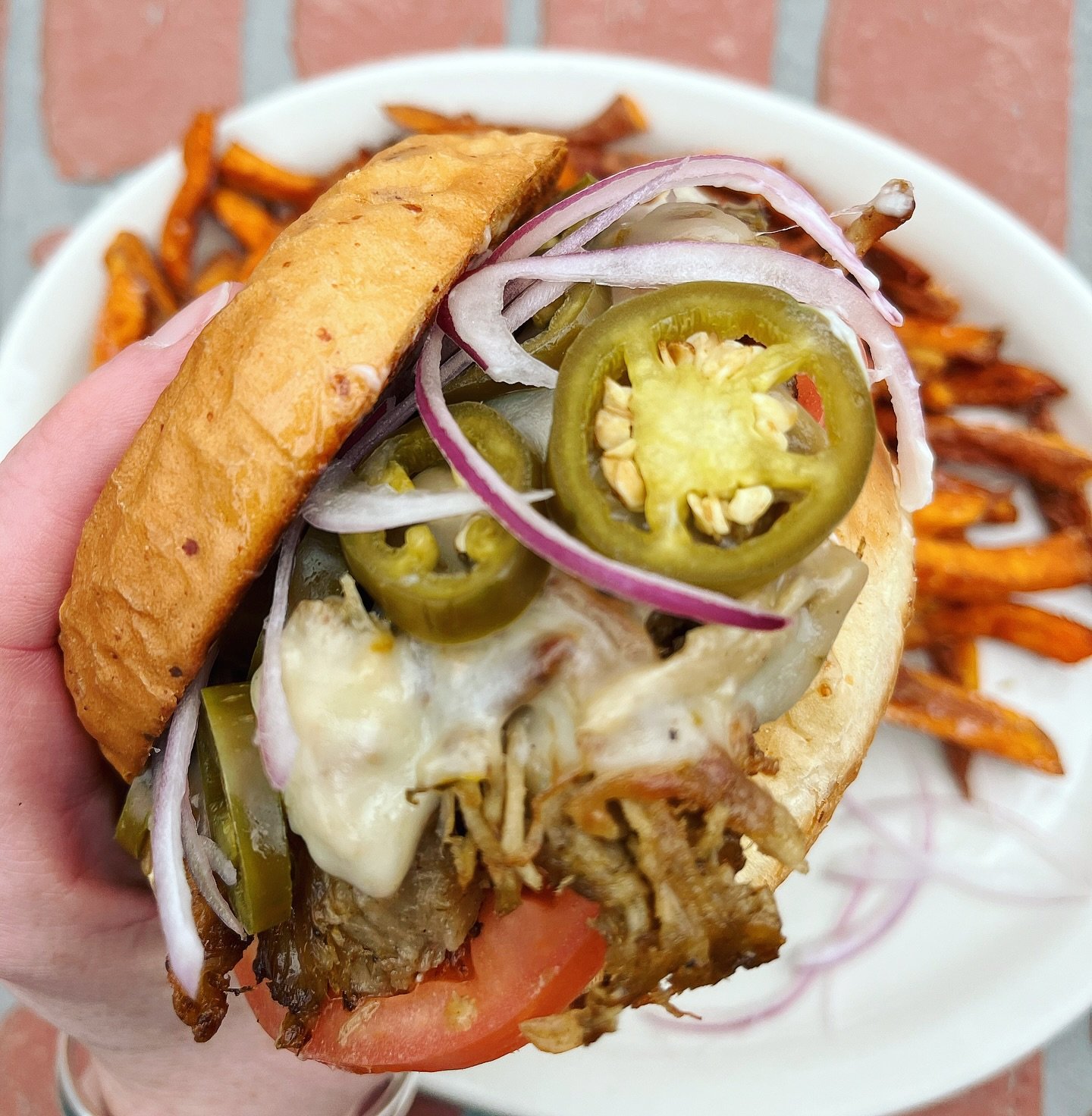 Lunch and dinner special...Cowboy Candy Pork Sandwich! Caramelized grilled Cuban pulled pork, on a parmesan bun with tomato, pickled jalape&ntilde;o, red onion, mayo and melted pepper jack cheese, served with your choice of side.