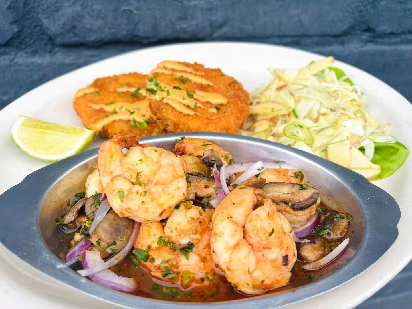 Chipotle Shrimp for our lunch &amp; dinner special. Wild Mexican shrimp simmered in chipotle stock with mushrooms and onions. Served with chorizo and cheese potato patties and apple fennel slaw.