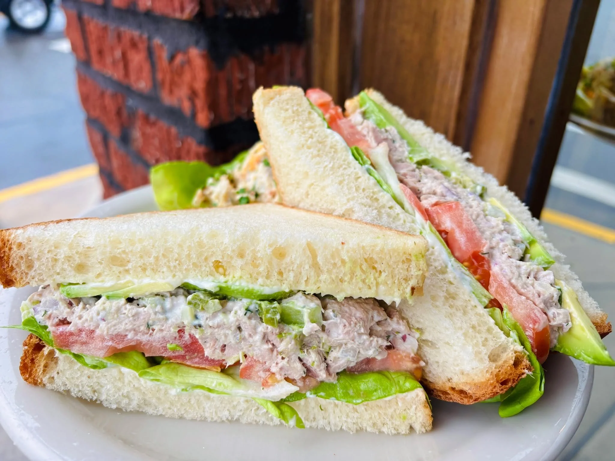 🐟 Fresh, simple, and seriously good. Our Tuna Sandwich is on special for lunch or dinner! House-made yellowfin tuna salad on honey white bread with lettuce, tomato, mayo, pickled jalape&ntilde;o, and fresh avocado. Served with your choice of side.