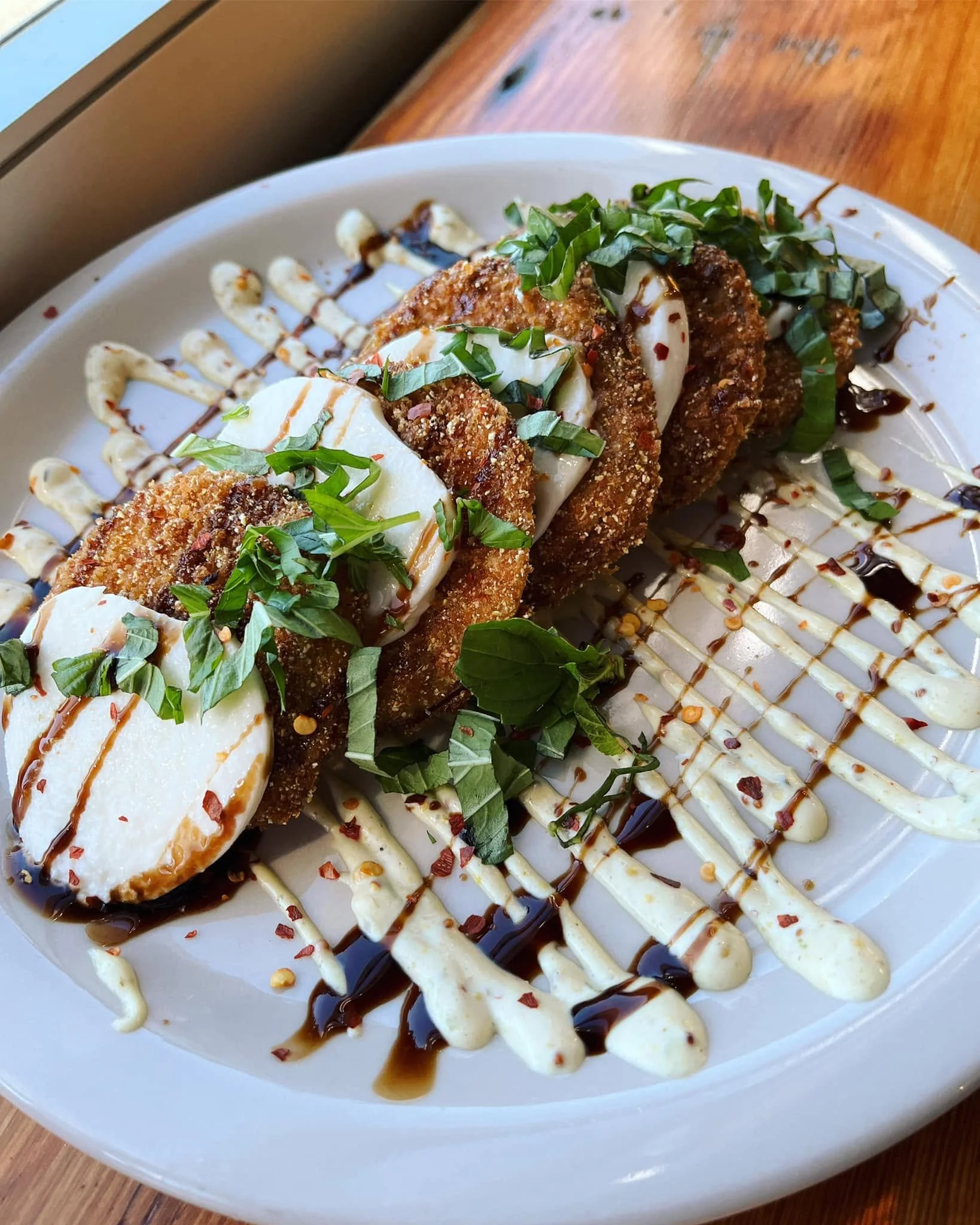 Great news for all of you fried green tomato fans...we've added our Fried Green Tomato Caprese to the menu for the rest of summer!  Breaded green tomatoes crispy fried and layered with fresh mozzarella. Topped with basil, balsamic reduction, remoulad