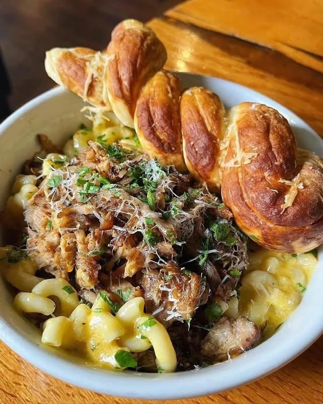 Cozy up with Smoked Pork Mac &amp; Cheese! Cavatappi pasta tossed in creamy smoked gouda cheese sauce and topped with house smoked BBQ pork &amp; parmesan. Served with house baked pretzel twist, $20.