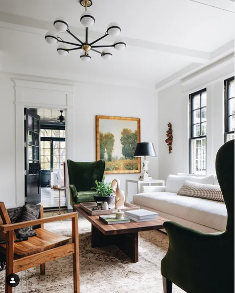 Light-filled Palm Beach living room with green velvet wing chairs