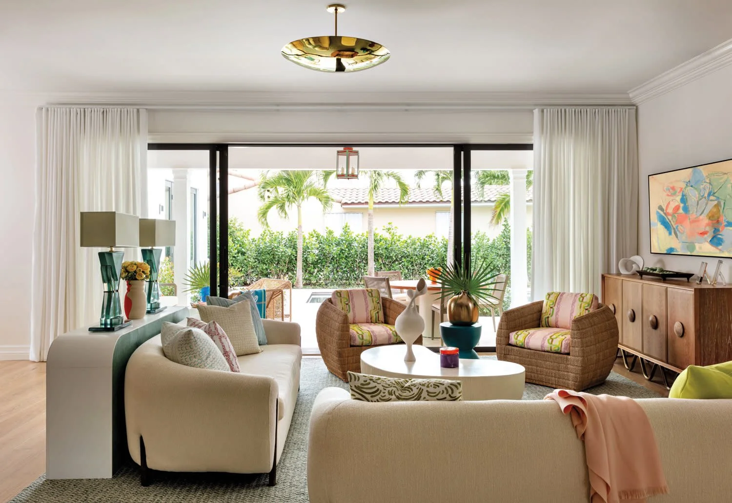 Palm Beach living room with curved sofas and indoor-outdoor feel