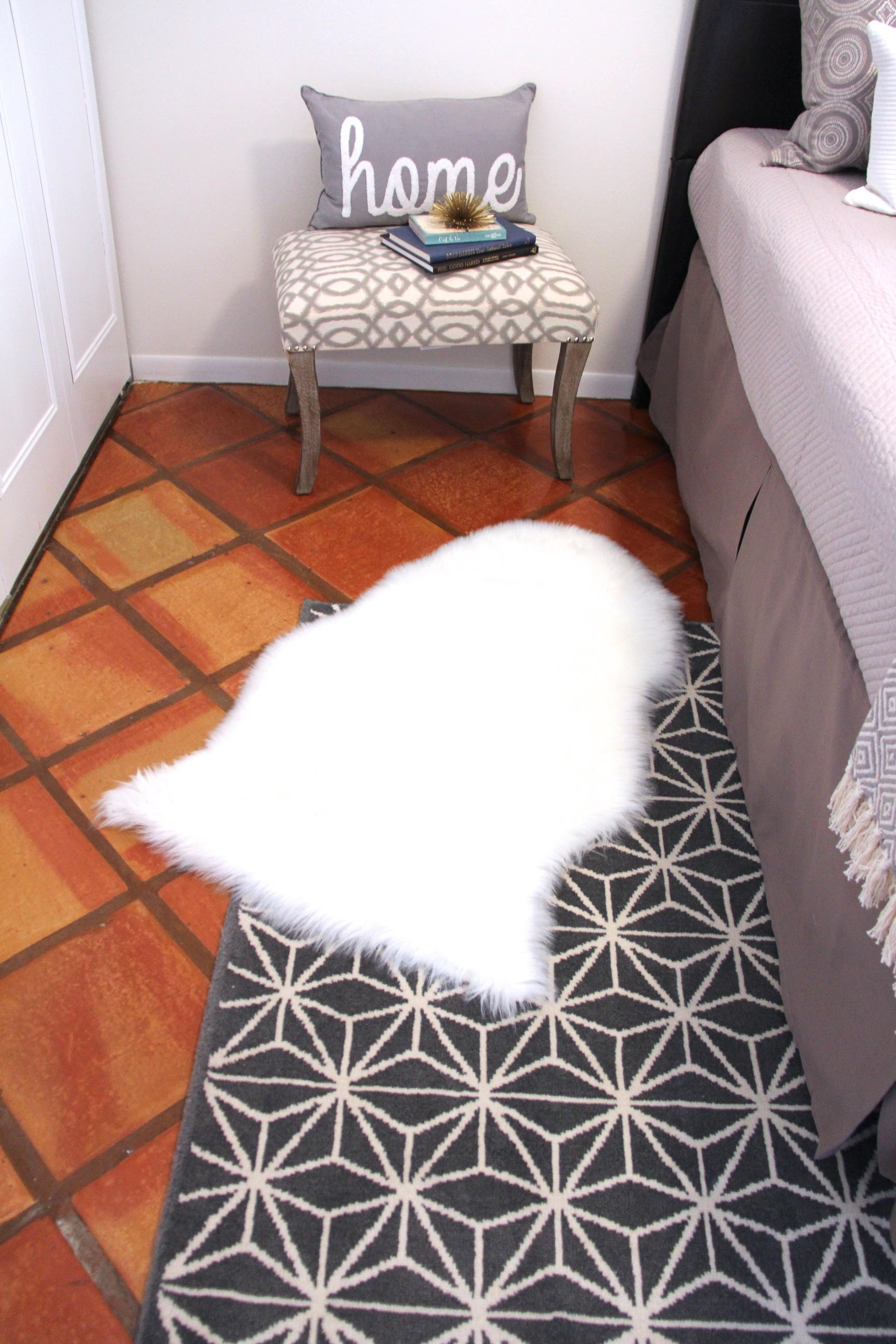 Staged bedroom with luxury sheepskin rug