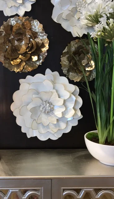 Luxe home styling a delray beach home wall with rosettes, white planter, and metallic sideboard