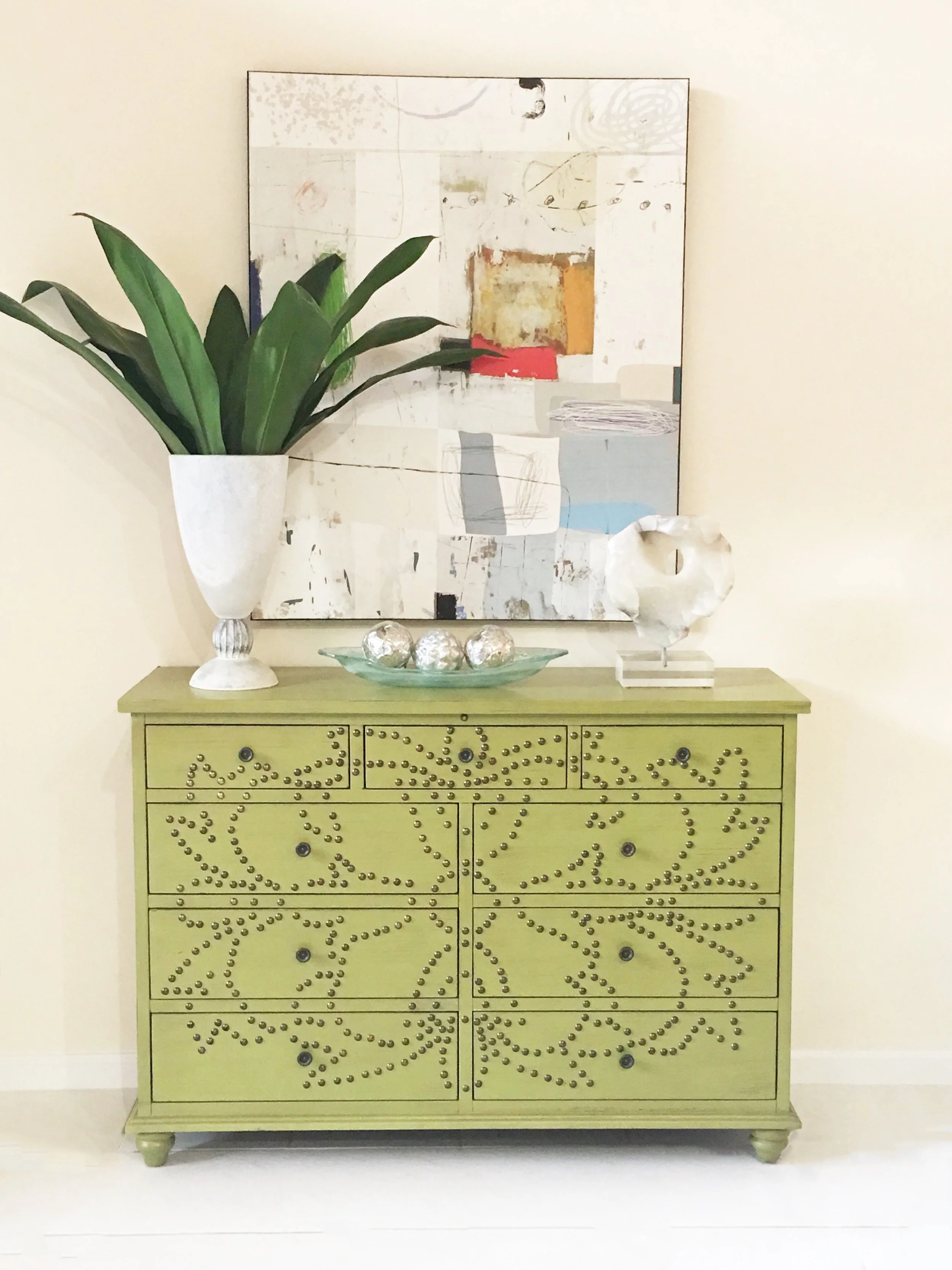 home staging delray beach, fl of a greed sideboard with tall vase and modern artwork