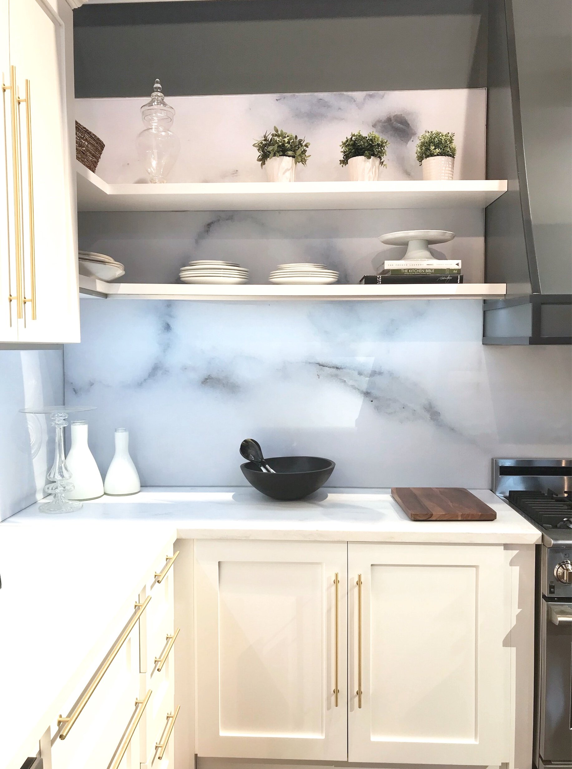 Kitchen  off white cabinetry with marble backsplash and open shelves 