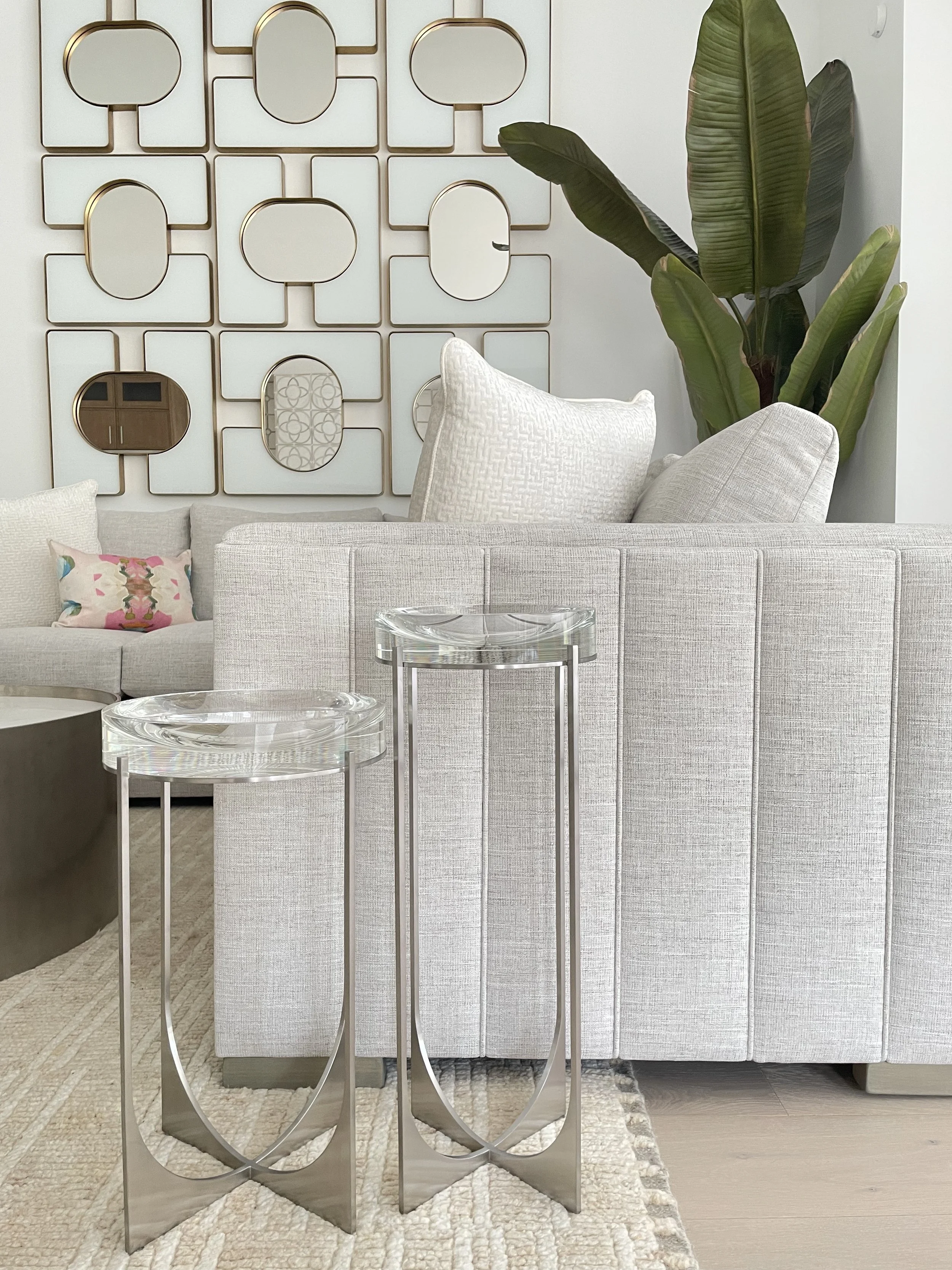 Palm Beach full-service luxury interior design living room shows a fully designed cohesive living room with a bespoke sofa with channels in an oatmeal fabric, with crystal and steel tables.