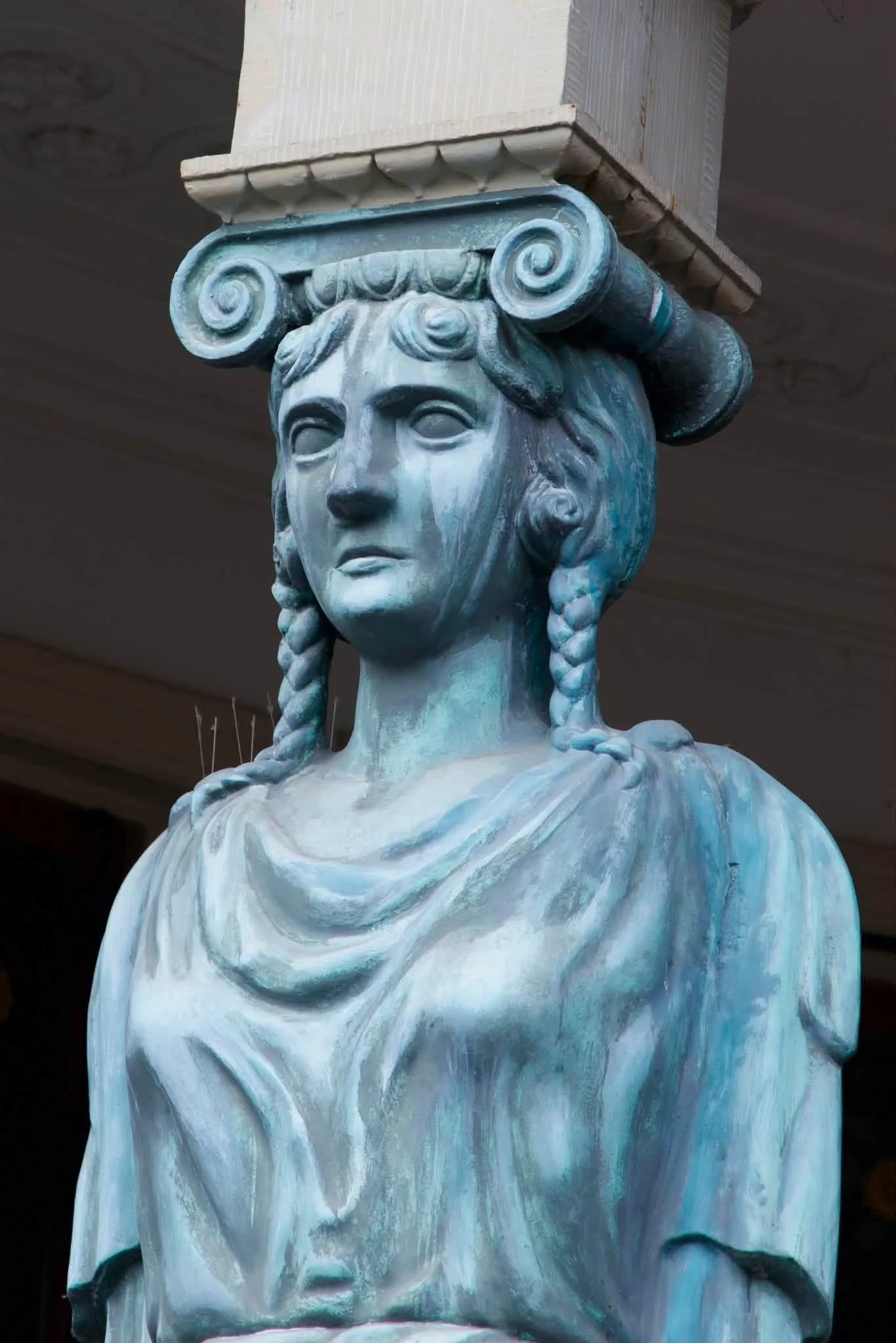 A close up of the Winkel van Sinkel caryatid in verdigris.