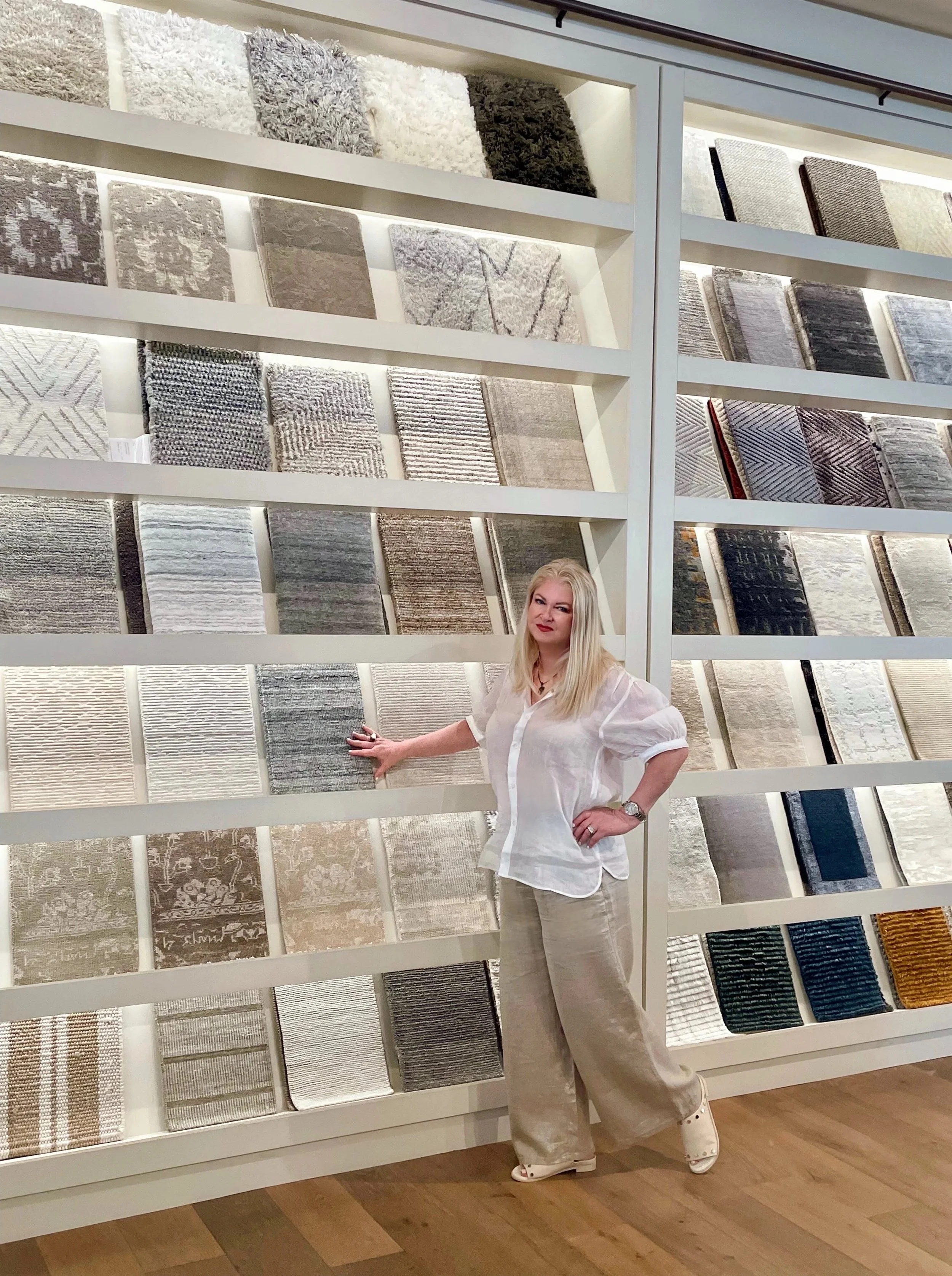 Interior Designer Denise Jadd is seen sourcing rugs in the library for a living room.