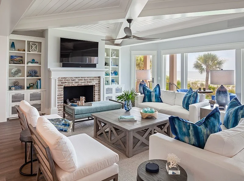 White coastal living room in Palm Beach with blue accents and water view