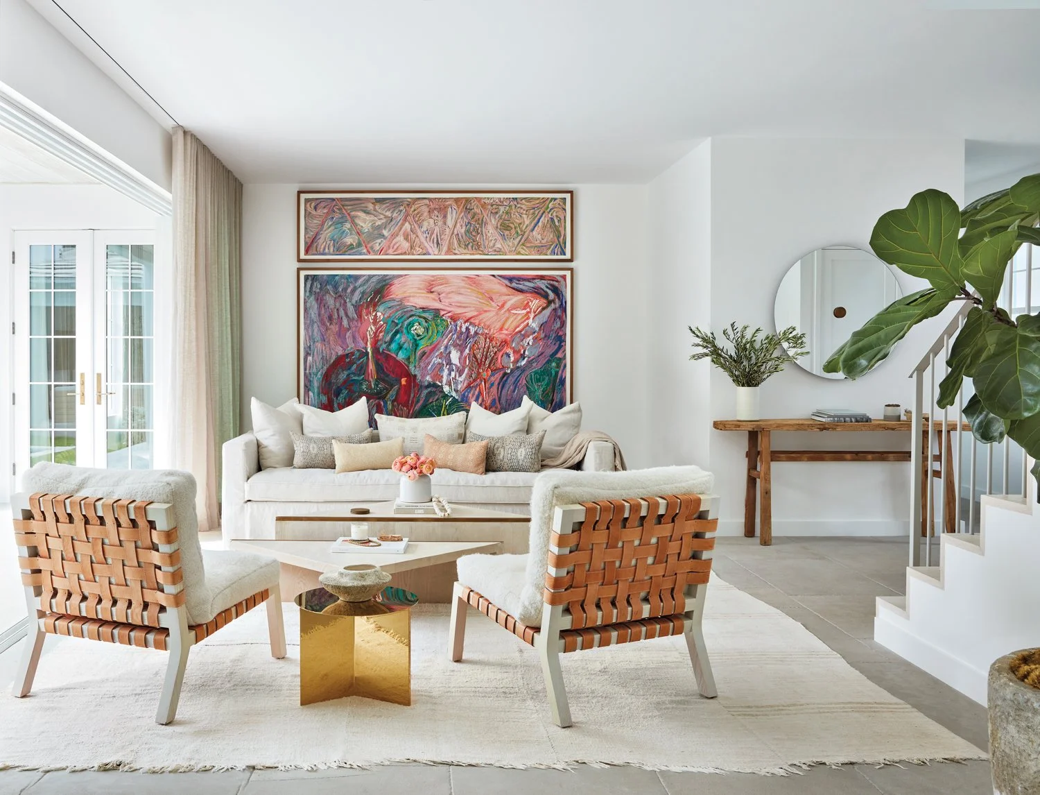 Colorful Delray Beach coastal living room with rattan chairs and tropical art.