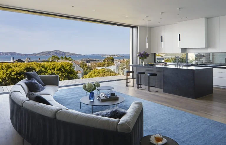 Contemporary luxury Palm Beach inspired living area with panoramic water views and sleek furnishings