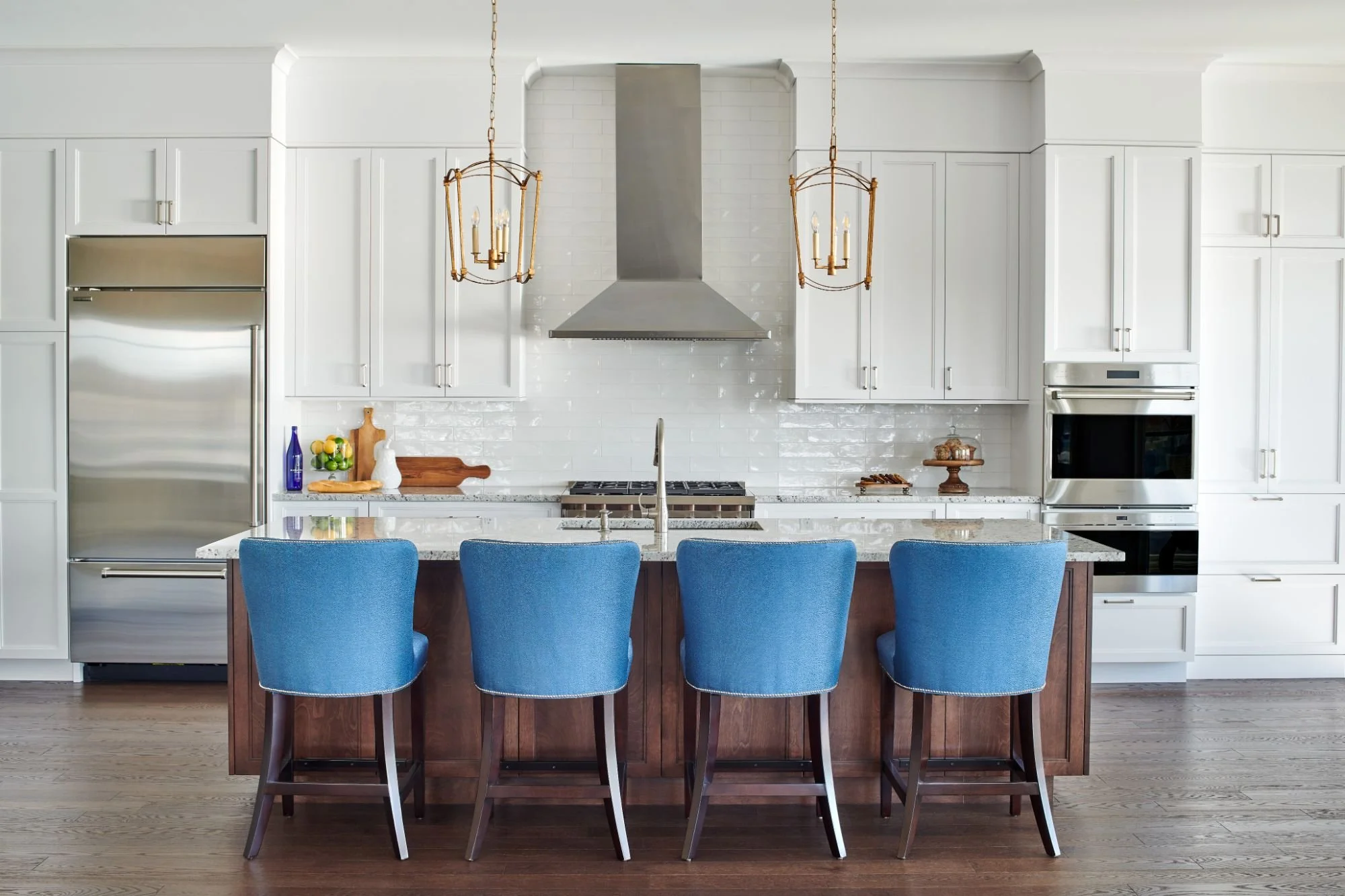 Transitional kitchen with white cabinets and blue barstools