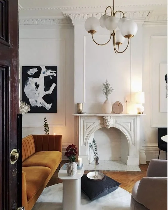 Euro-chic Palm Beach sitting room with sculptural fireplace and art
