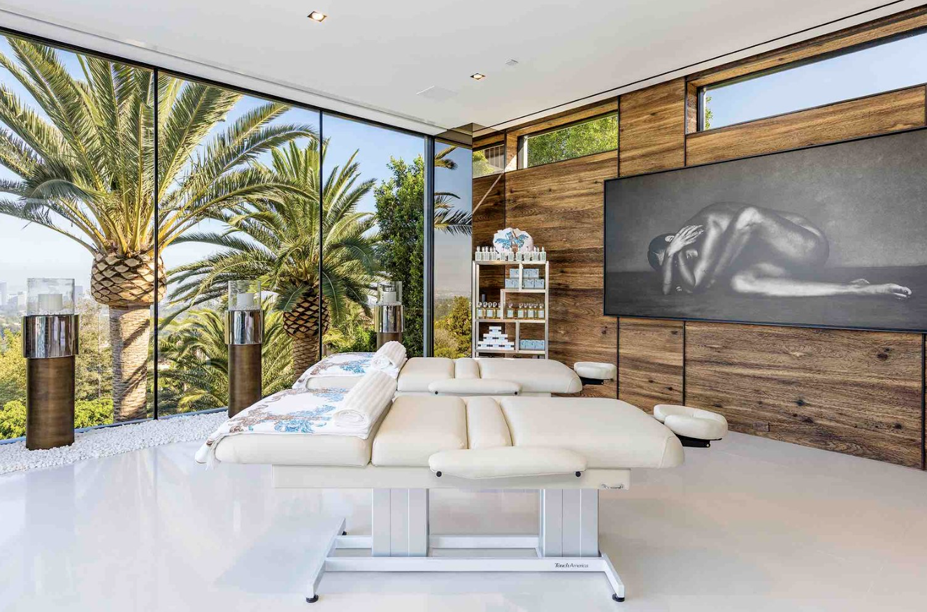 Modern Palm Beach luxury wellness room with massage tables and palm tree views