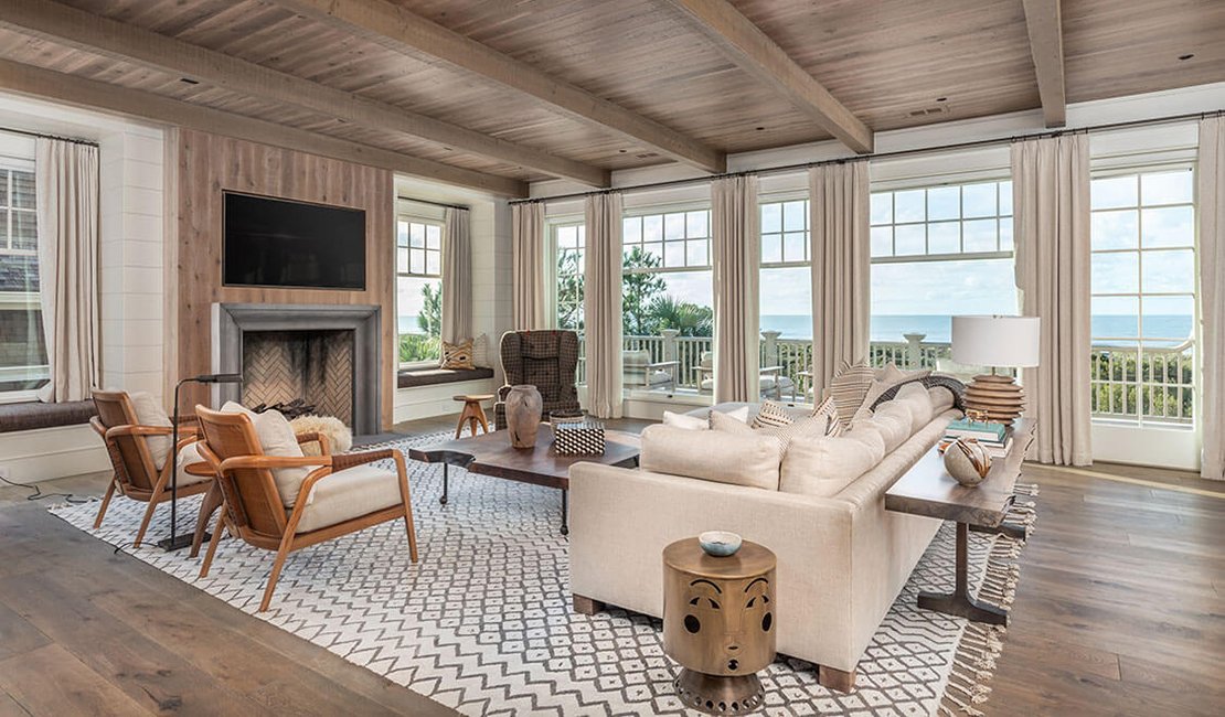 Palm Beach coastal living room with warm neutral layered textures, modern furnishings, with ocean views.