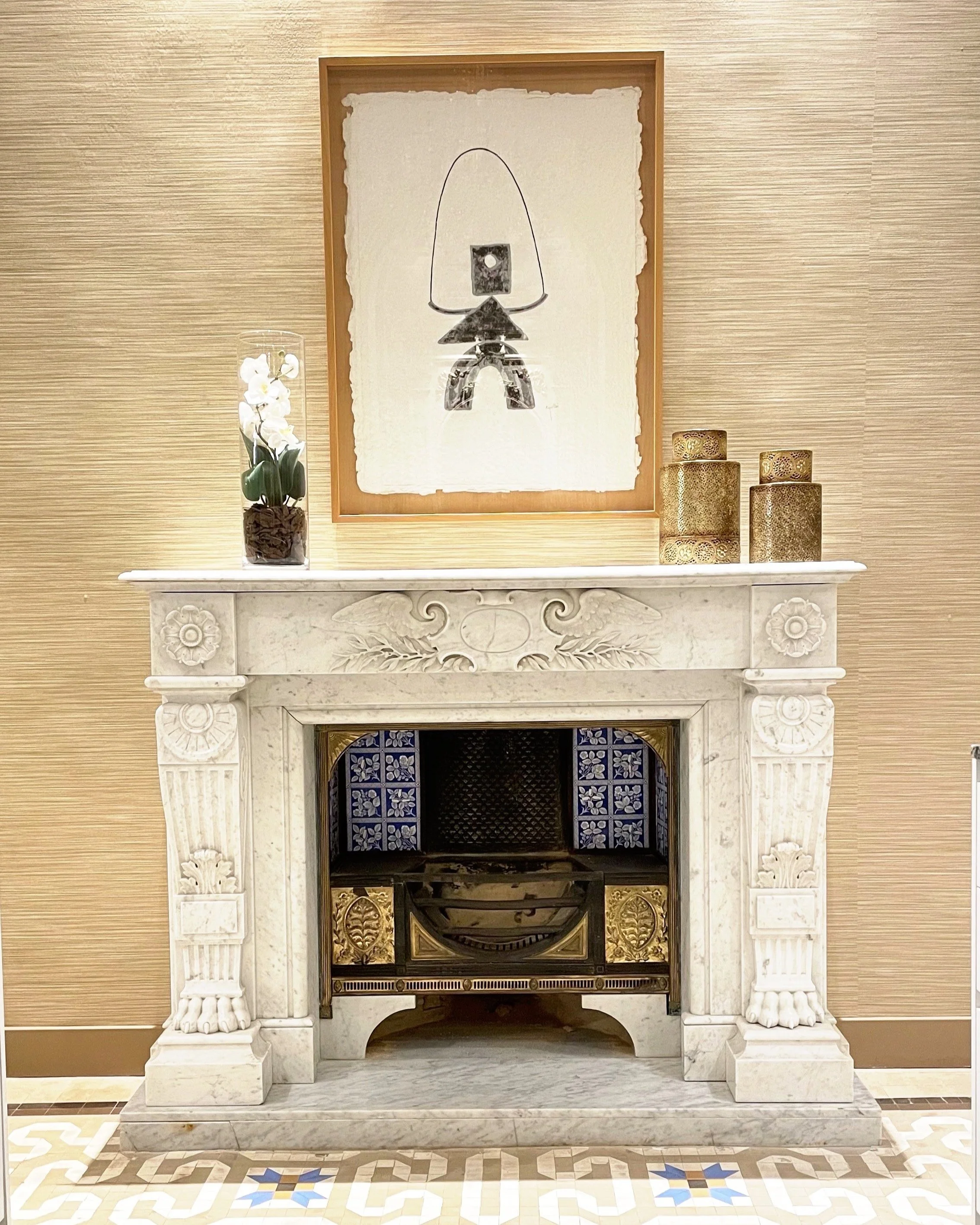 Domaine Luxe luxury interior design shows an artist display blending with an antique fireplace.