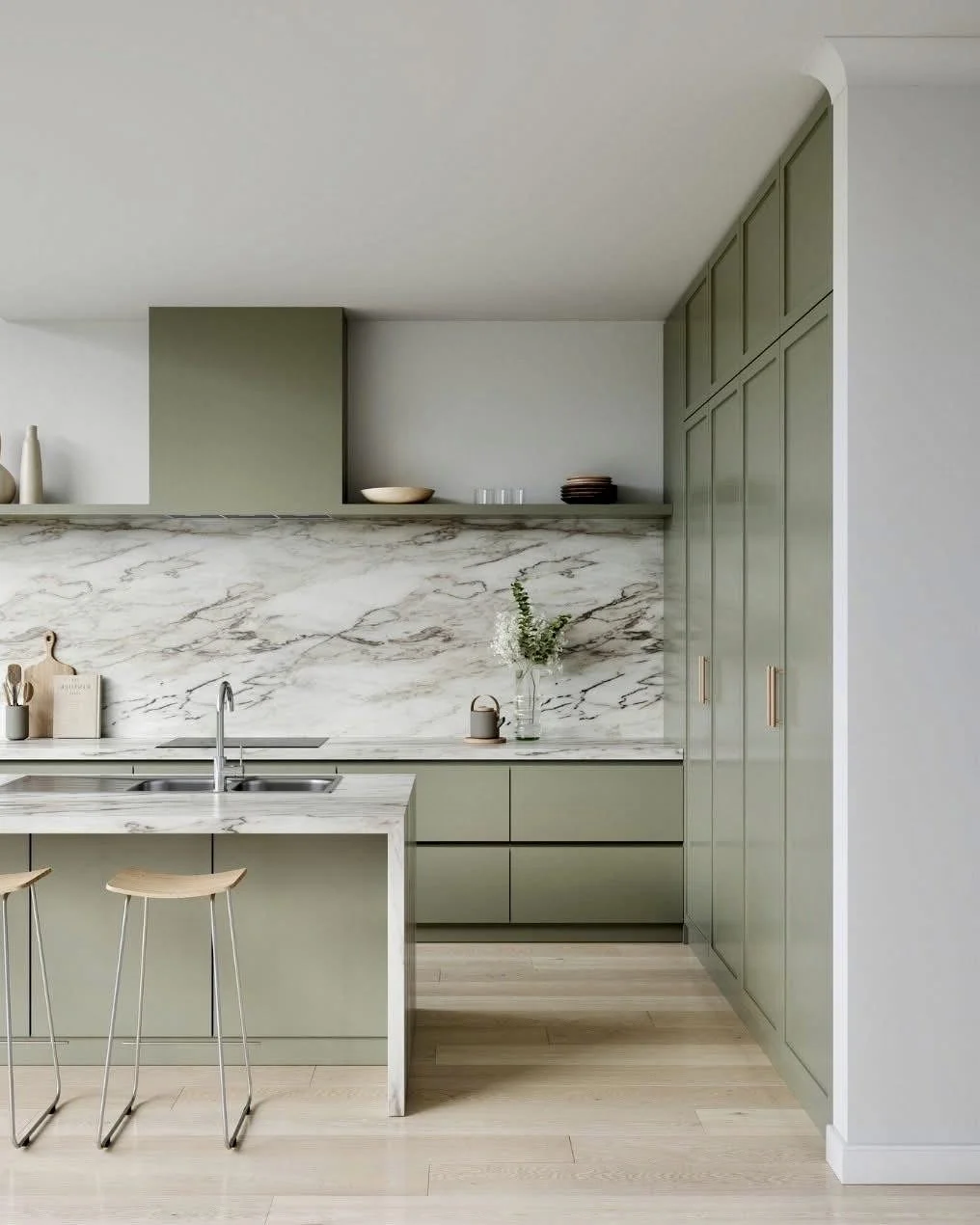A Delray Beach minimal kitchen in sage green is paired with white marble countertops and matching backsplash, creating a timeless calm aesthetic.